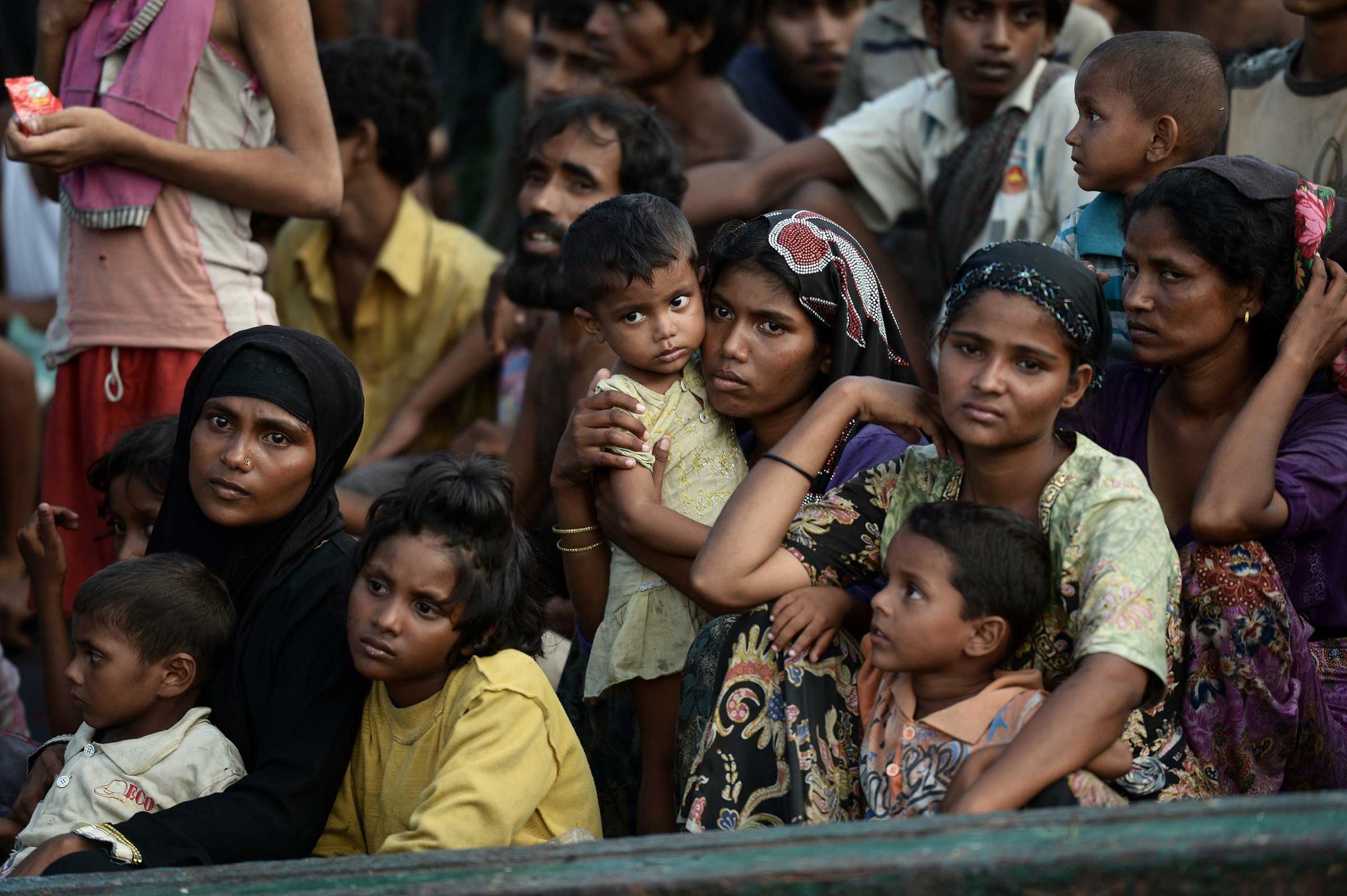 Rohingya migrants sit on a boat drifting in Thai waters off the southern island of Koh Lipe in the Andaman sea on May 14, 2015.