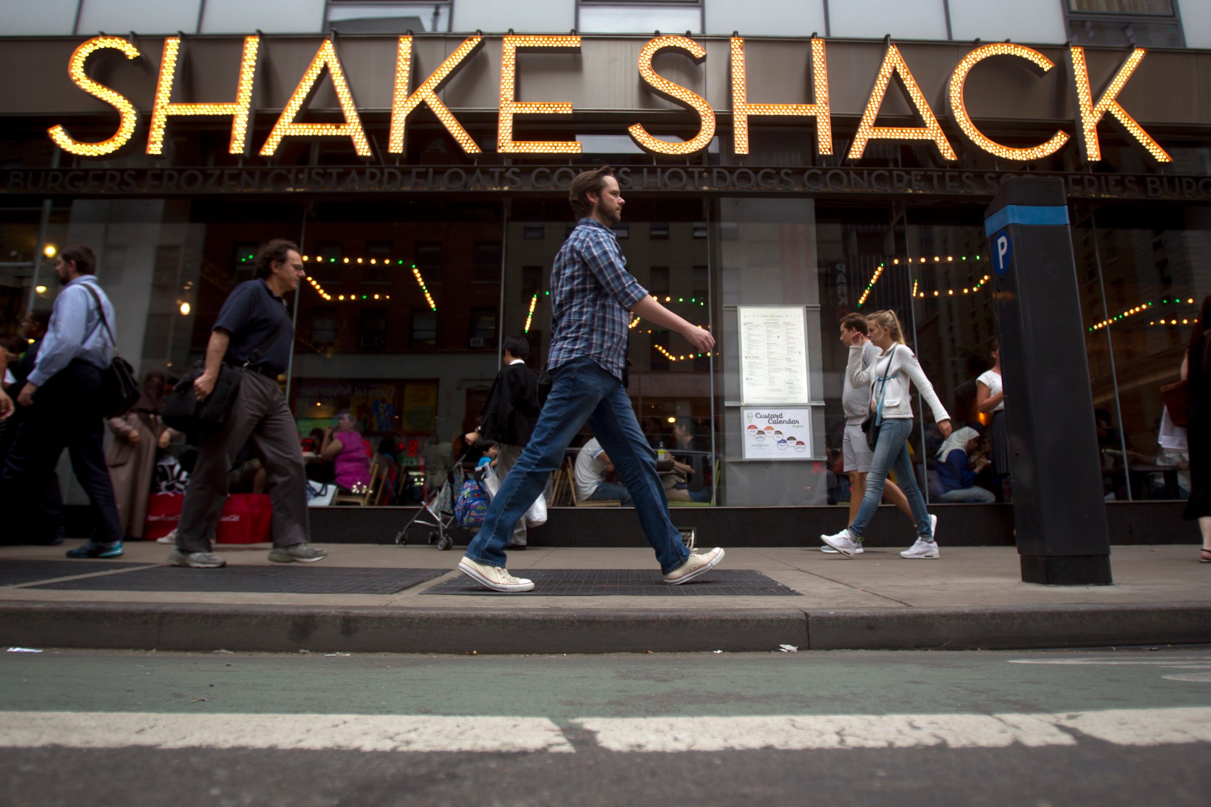 People walk past a Shake Shack restaurant in New York
