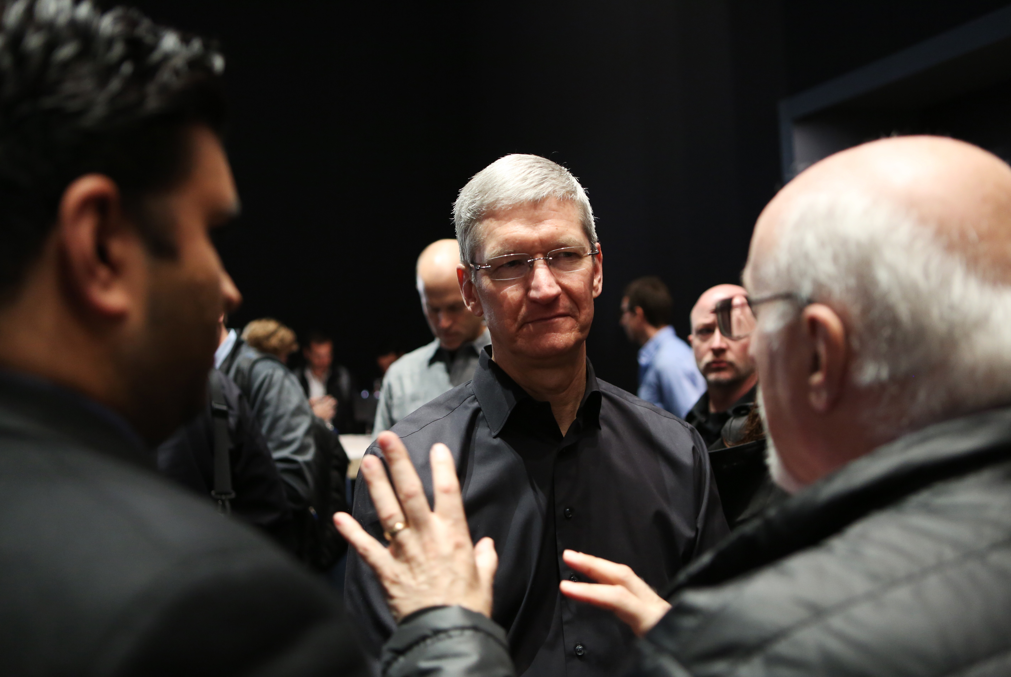 Apple Inc. CEO Tim Cook talks to tech writer Walt Mossberg during an Apple event in San Francisco