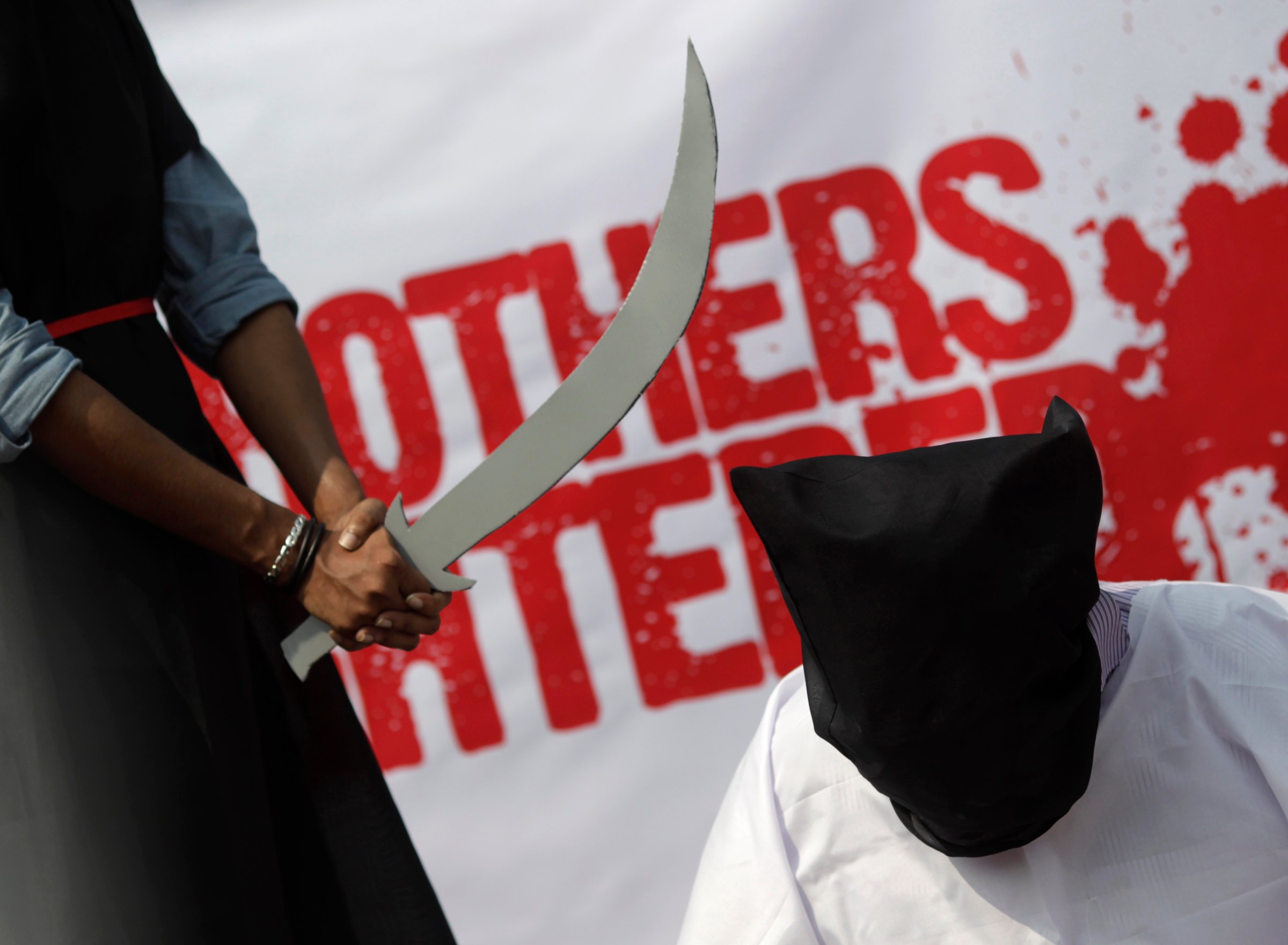 A mock execution scene in protest of Saudi Arabia beheadings in Dhaka October 15, 2011