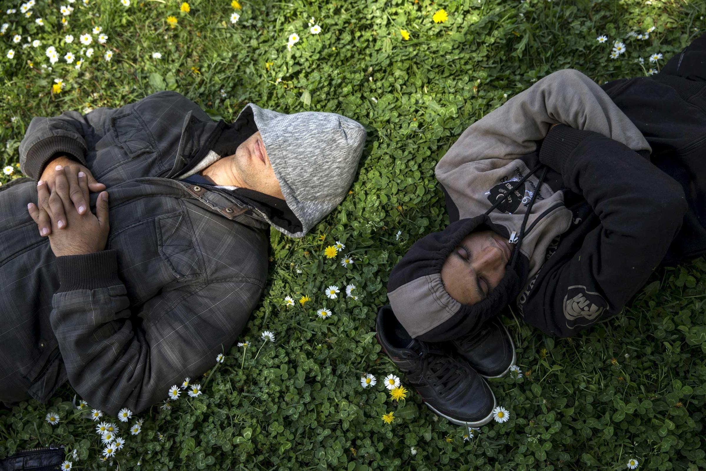 Migrants sleep in a park near the main Belgrade's bus and train station, Serbia on April 24, 2015.