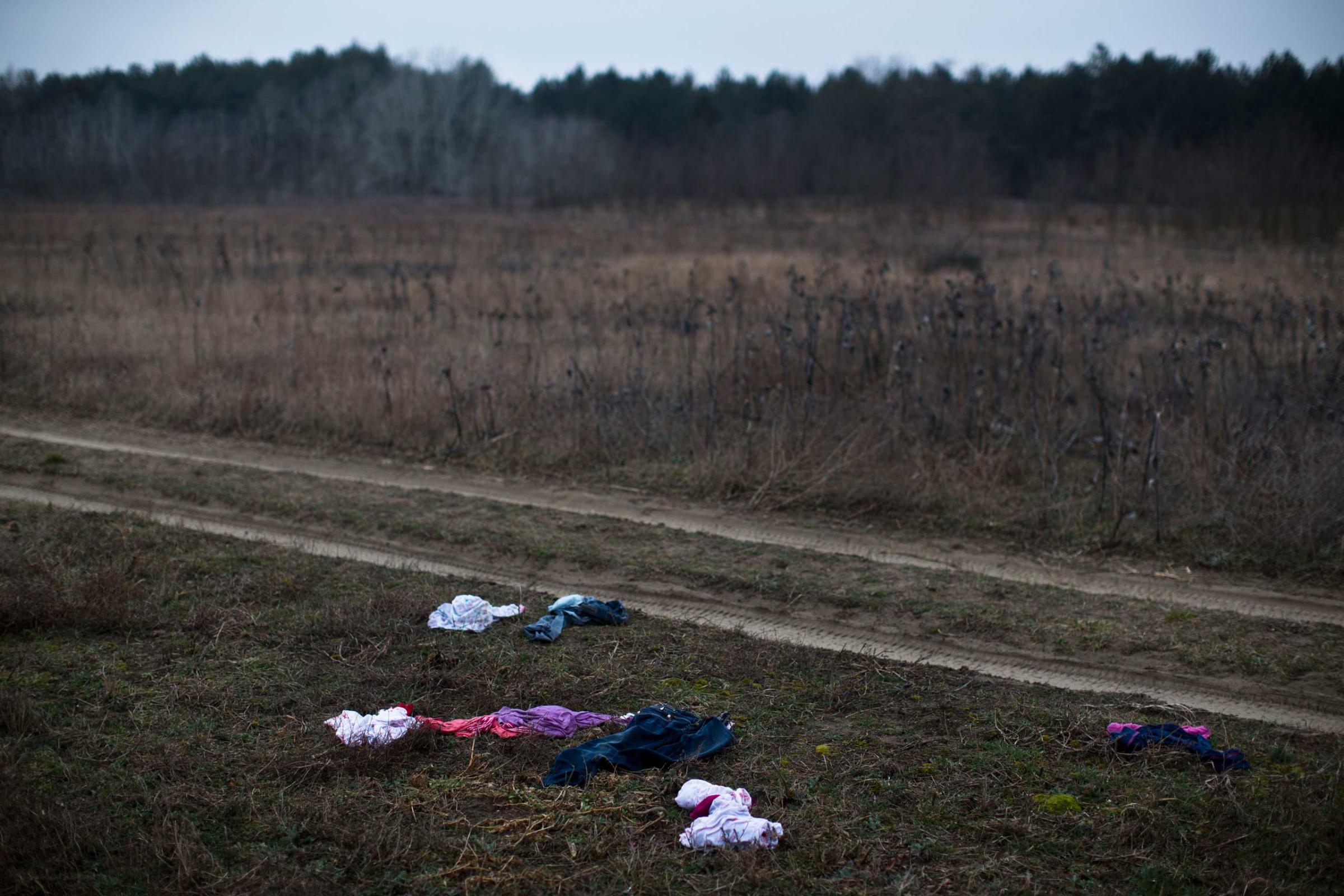 Discarded children's clothes are seen laying in a field meters away from the Serbian border with Hungary close to Horgos, 90 miles north of Belgrade, Serbia on Feb. 26, 2015,