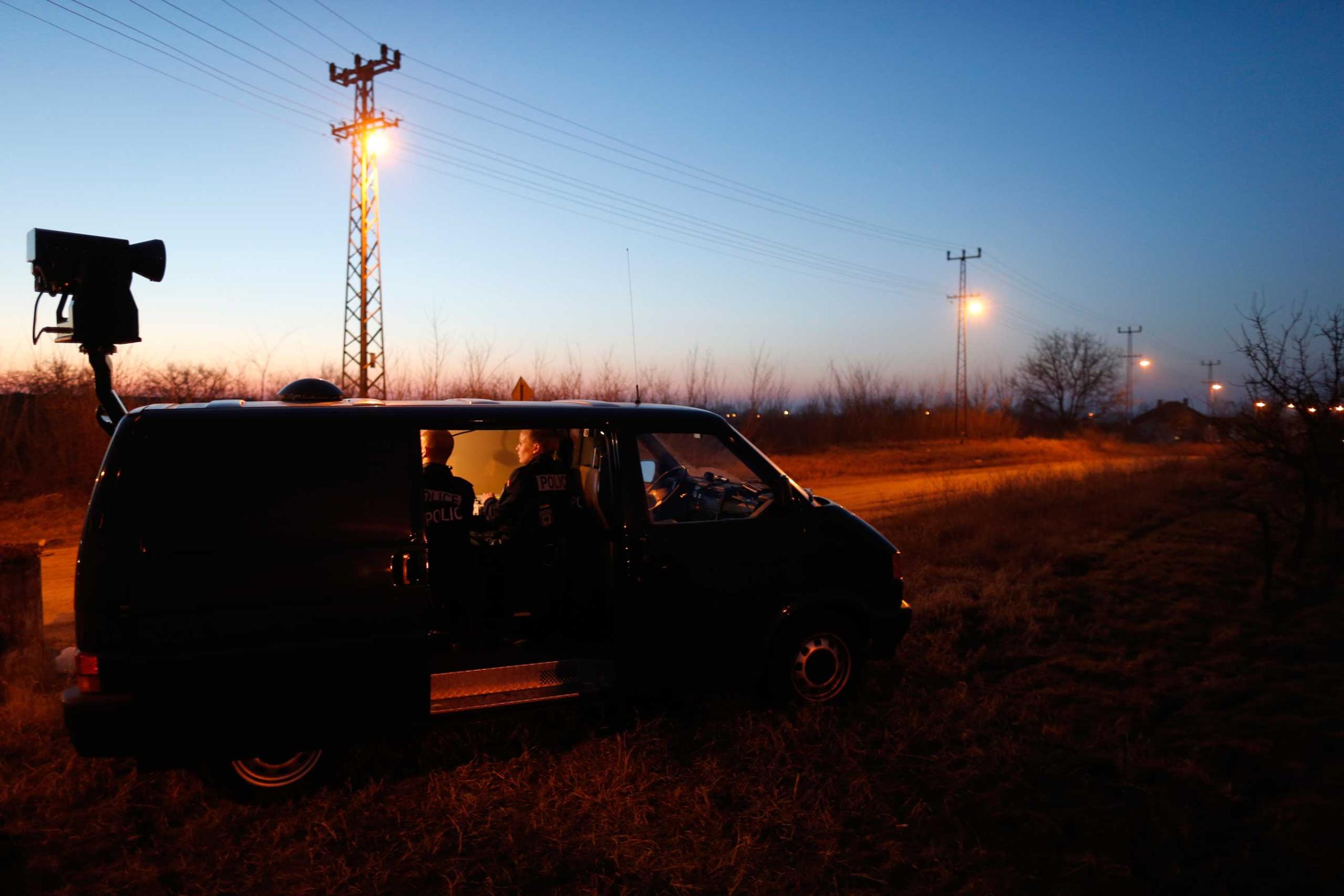 Members of the German border police sit in a van as they check a security camera while monitoring a stretch of the Serbian border with Hungary in the village of Hajdukovo, some 110 miles north of Belgrade, Serbia on Feb. 13, 2015.