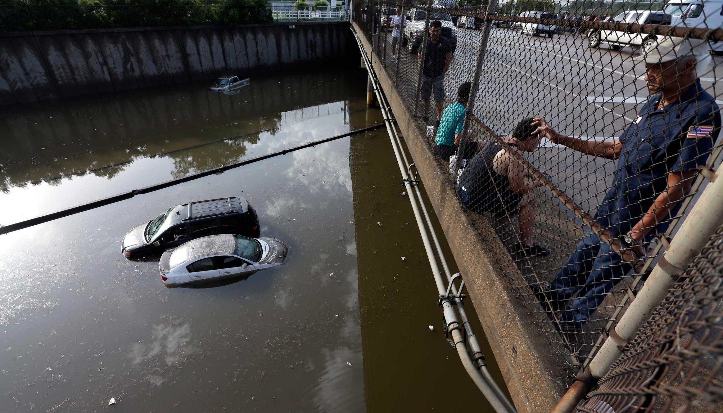 Cars sit in floodwaters along Interstate 45 after heavy overnight rain flooded parts of the highway in Houston on May 26, 2015.