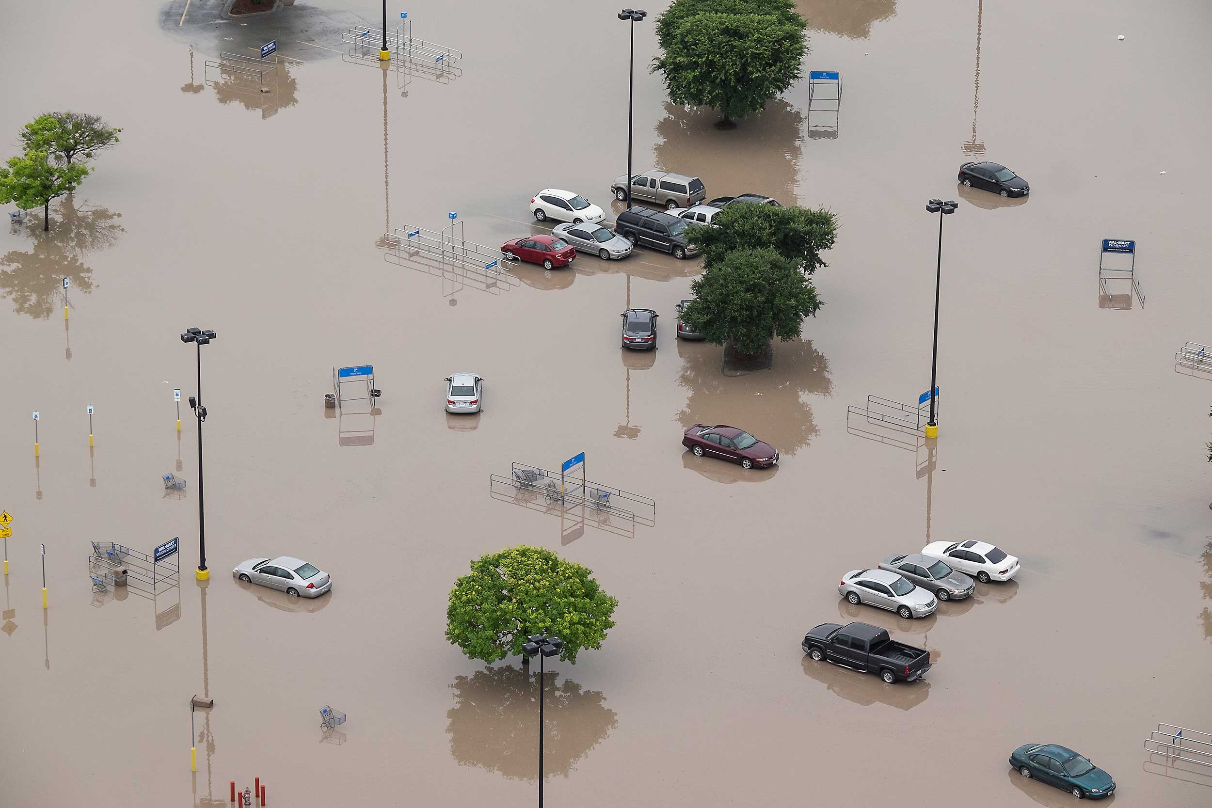 The parking lot of a Wal-Mart is submerged after the San Marcos River flooded in San Marcos, Texas on May 24, 2015.