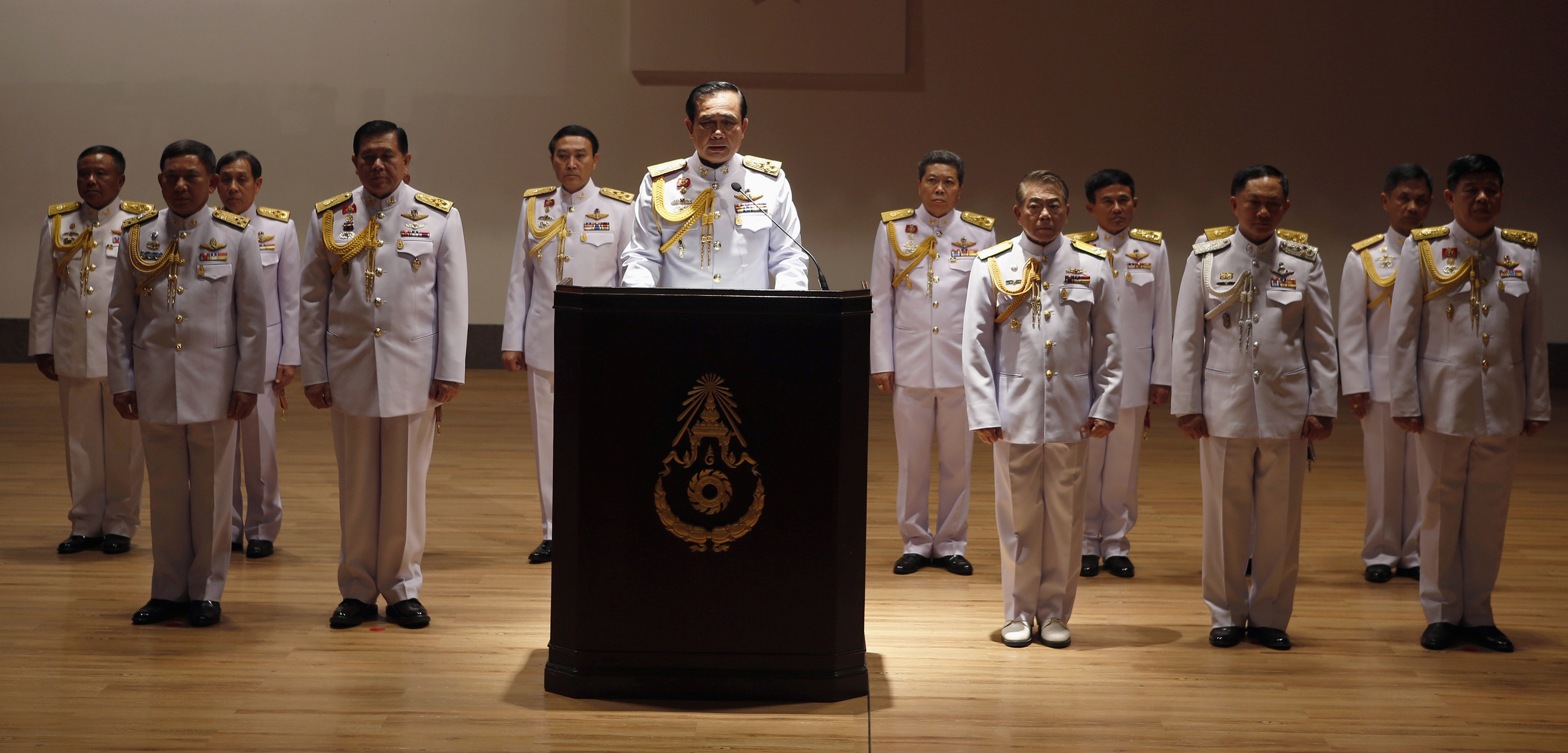 Prayuth, with his top officers, addresses reporters in Bangkok on May 26 last year after taking power as the head of the junta. (Erik De Castro—Reuters)