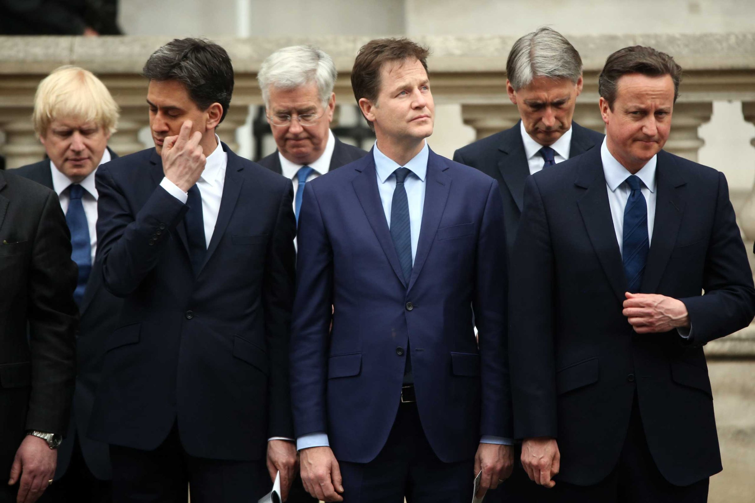 Labour Party leader Ed Miliband, Liberal Democrat leader Nick Clegg and Prime Minister David Cameron stand during a tribute at the Cenotaph to begin three days of national commemorations to mark the 70th anniversary of VE Day on May 8, 2015 in London.
