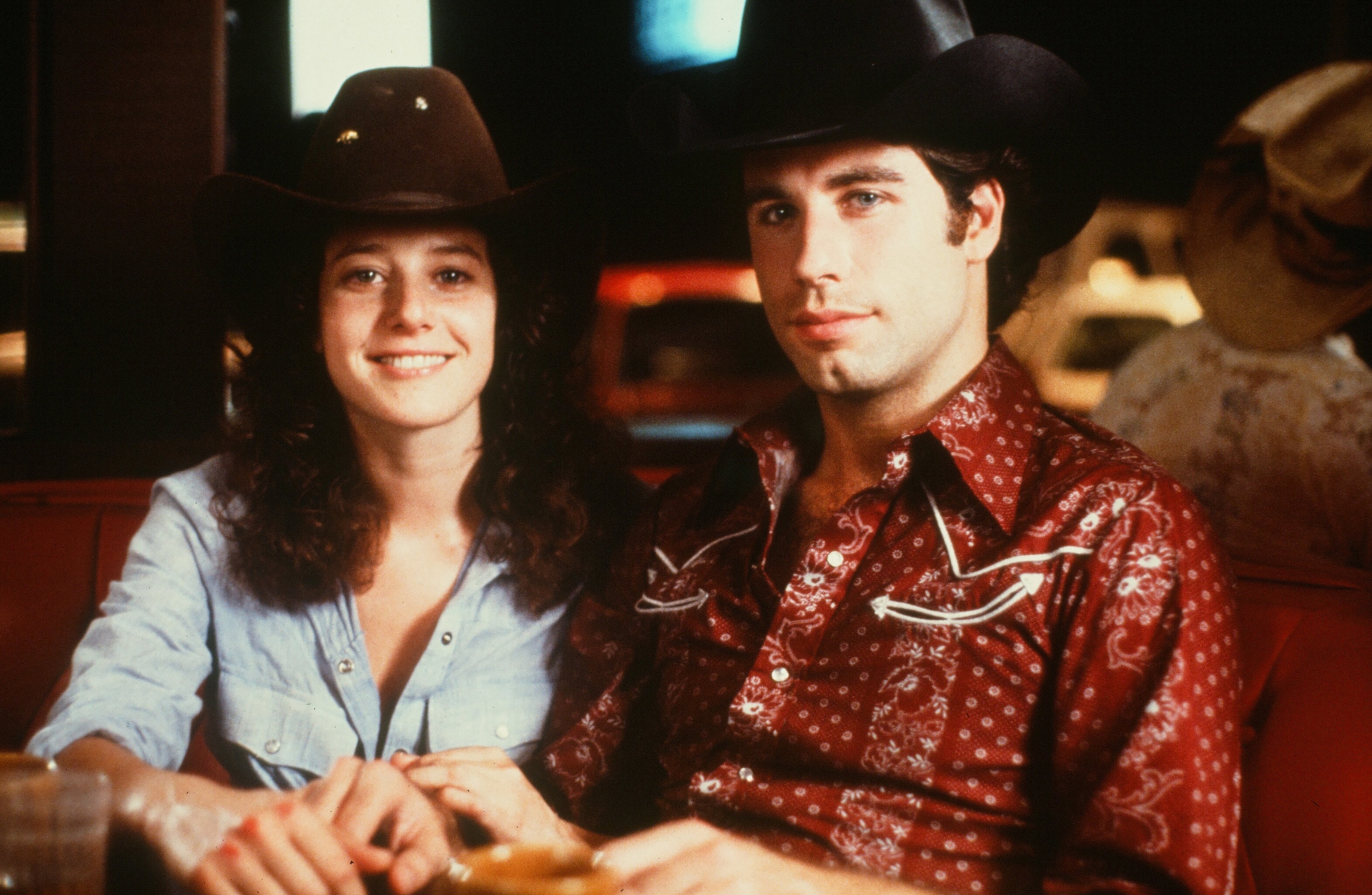 Actor John Travolta and Debra Winger pose in a scene during the Paramount Pictures movie  'Urban Cowboy" circa 1980.