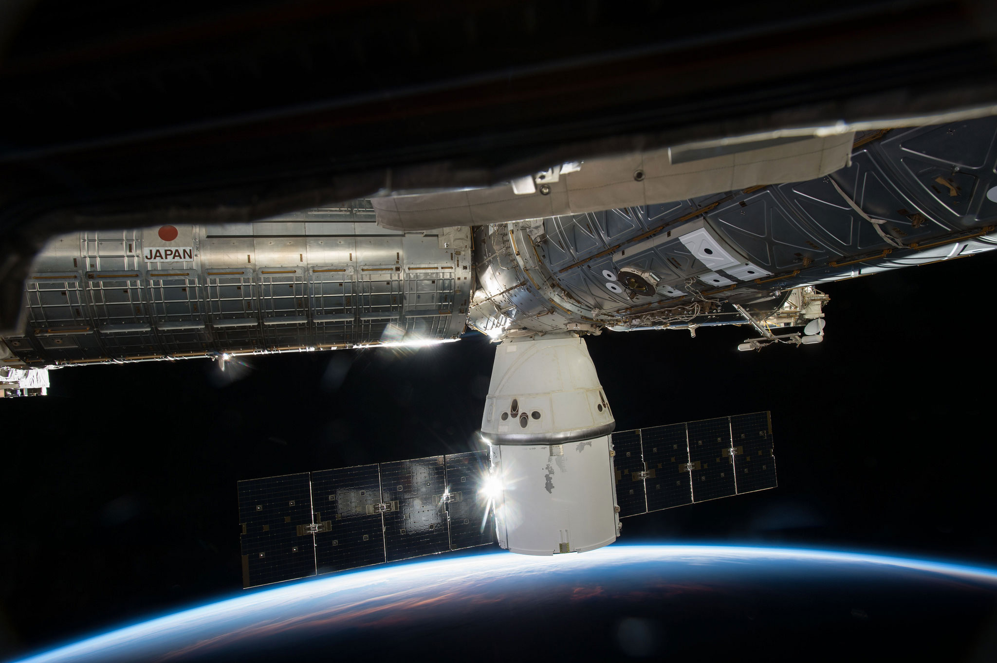 SpaceX's Dragon cargo capsule is seen here docked to the Earth-facing port of the Harmony module of the International Space Station. SpaceX's sixth commercial resupply flight arrived at the station on April 17.