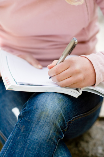 teenage-girl-writing-notebook