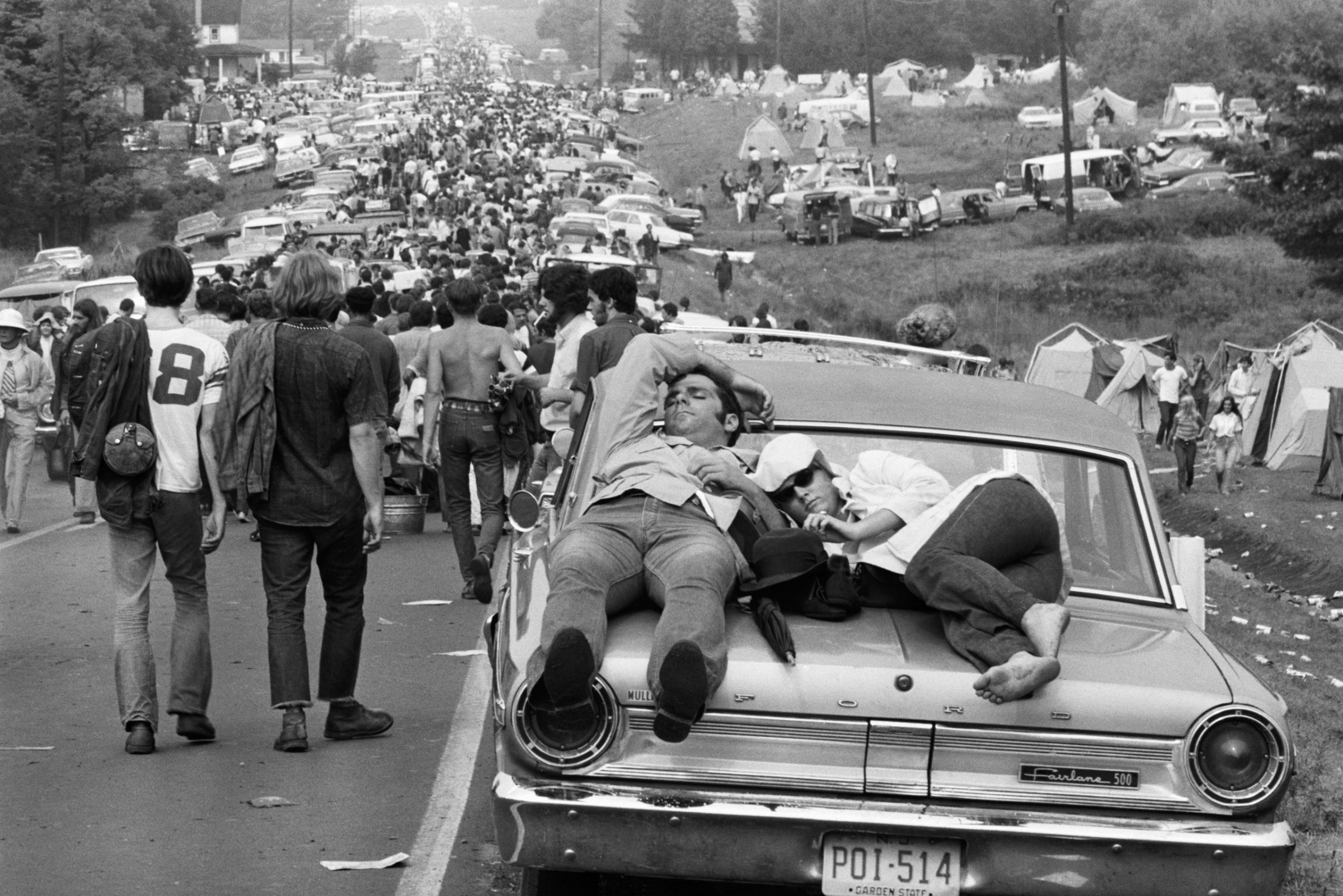 Couple Sleeping on Car at Woodstock, 1969