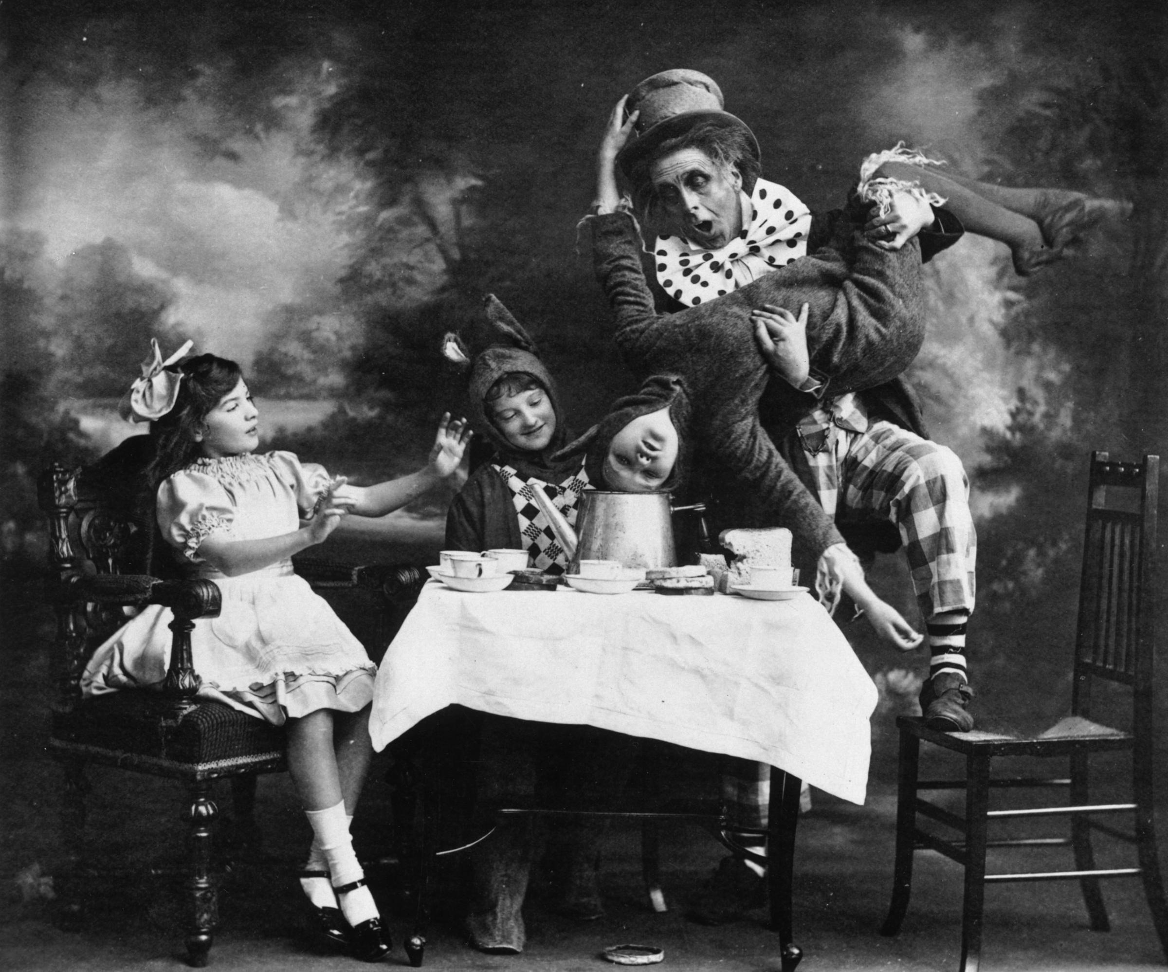 circa 1910: The Mad Hatter's tea party, a scene from a London theatre production of 'Alice In Wonderland'.
