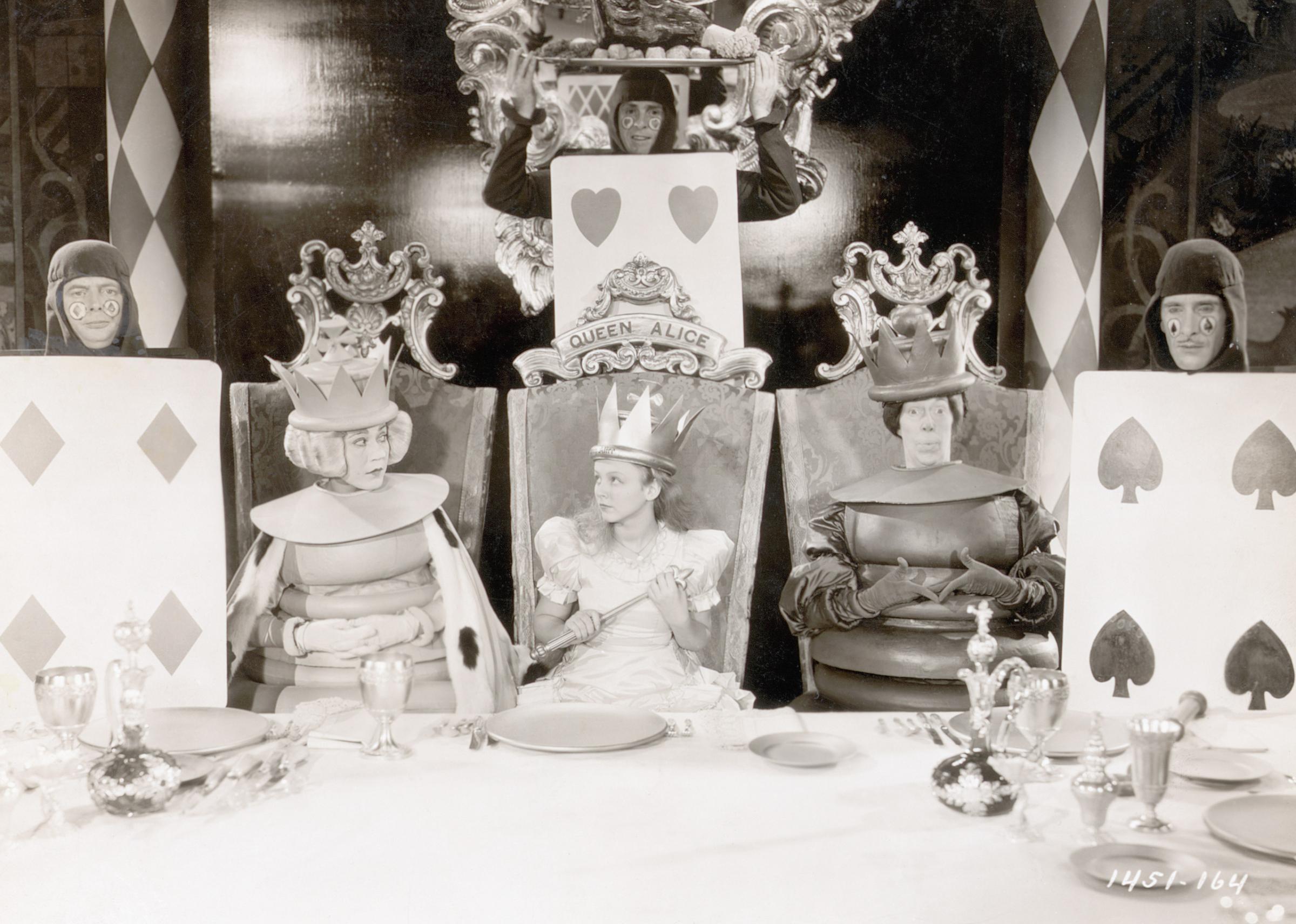 Scene from the movie, "Alice in Wonderland", written by Lewis Carroll. Alice (Charlotte Henry) is shown seated between the two chess pieces in a chair with "Queen Alice" written on it, 1933.