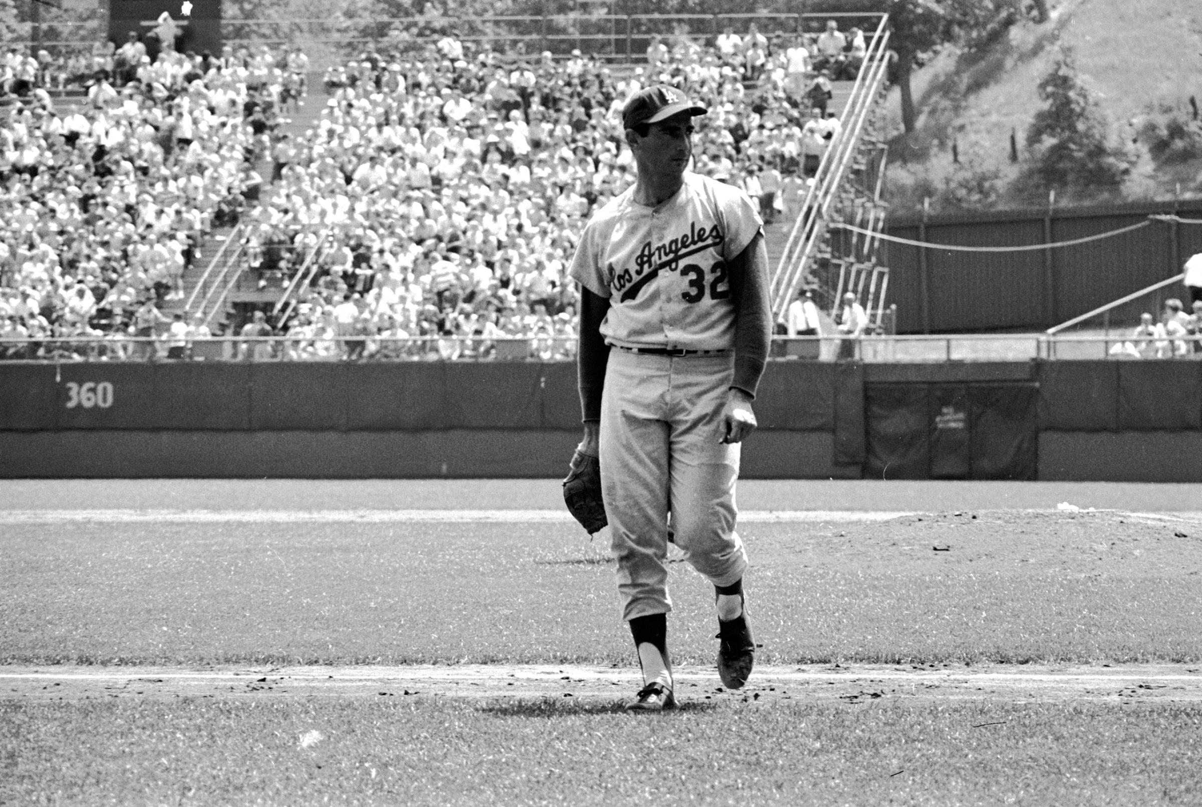 Los Angeles Dodgers pitcher Sandy Koufax taking the field during a game against the Milwaukee Braves, 1963.
