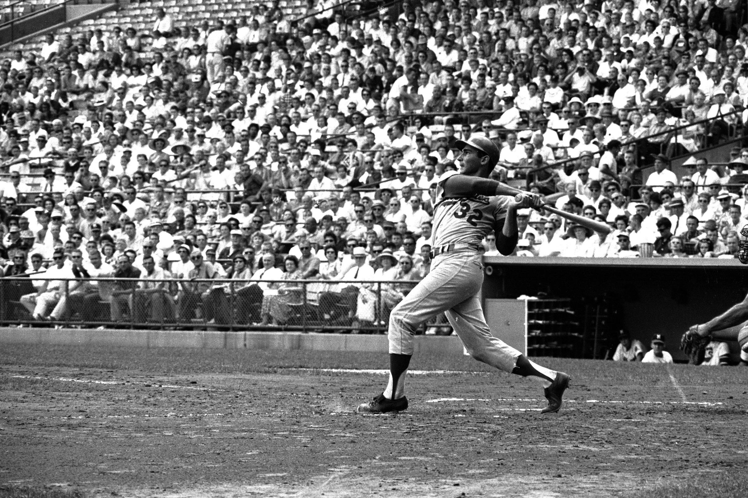Los Angeles Dodgers pitcher Sandy Koufax at bat during a game against the Milwaukee Braves, 1963.