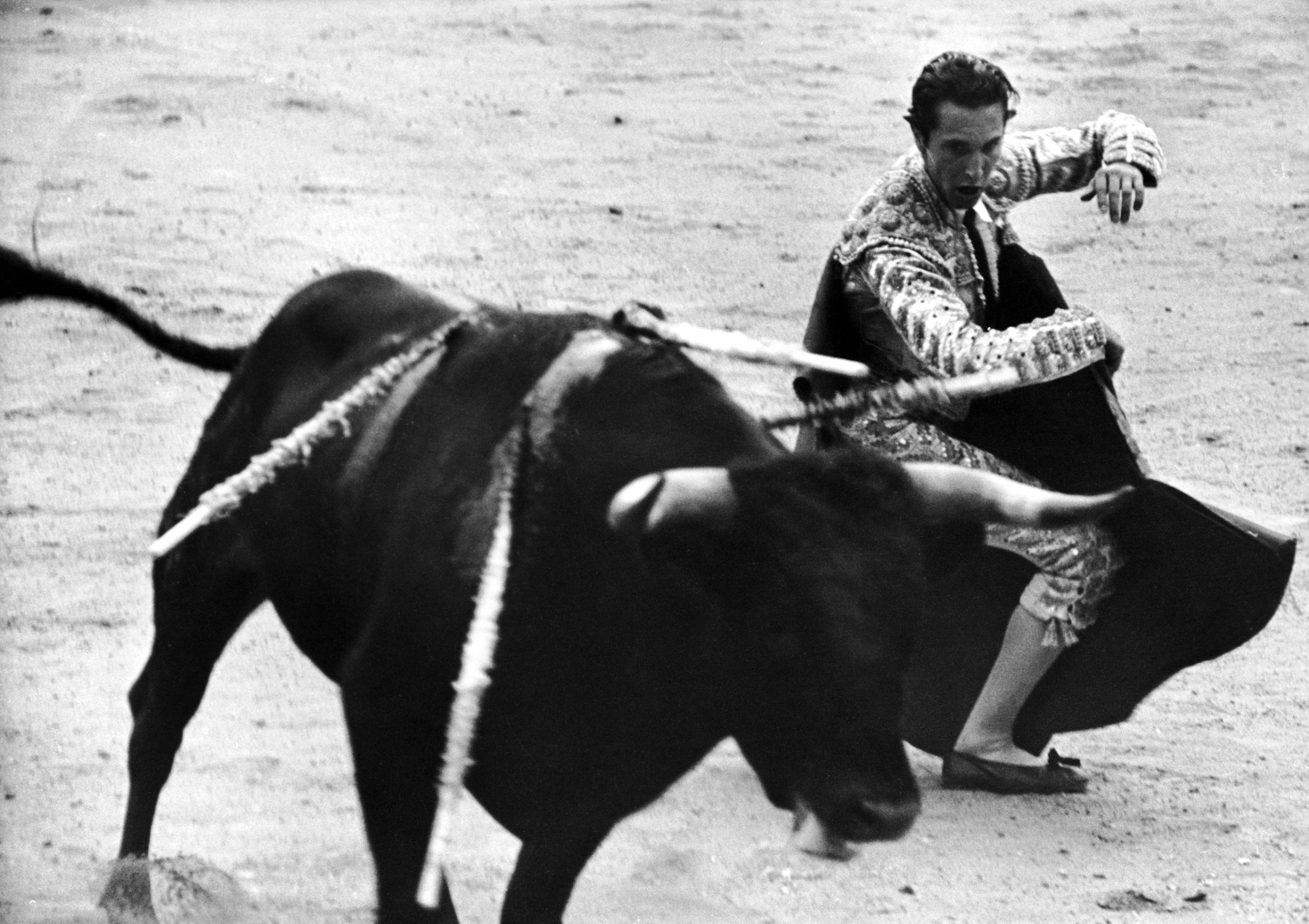 Matador Julian Marin and bull in the ring during a bullfight celebrating the Fiesta de San Fermín.