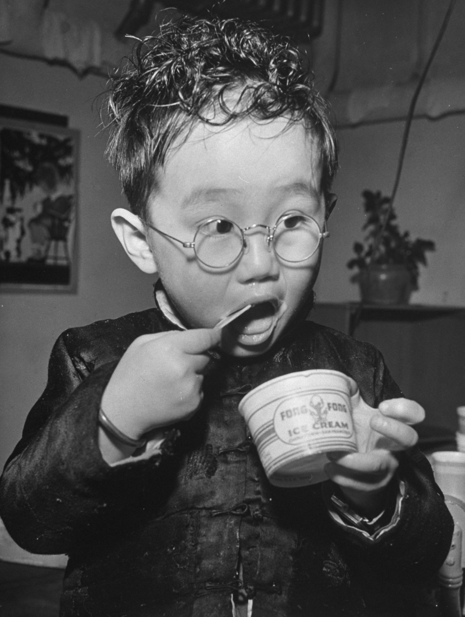 A young boy eating ice cream, 1942.