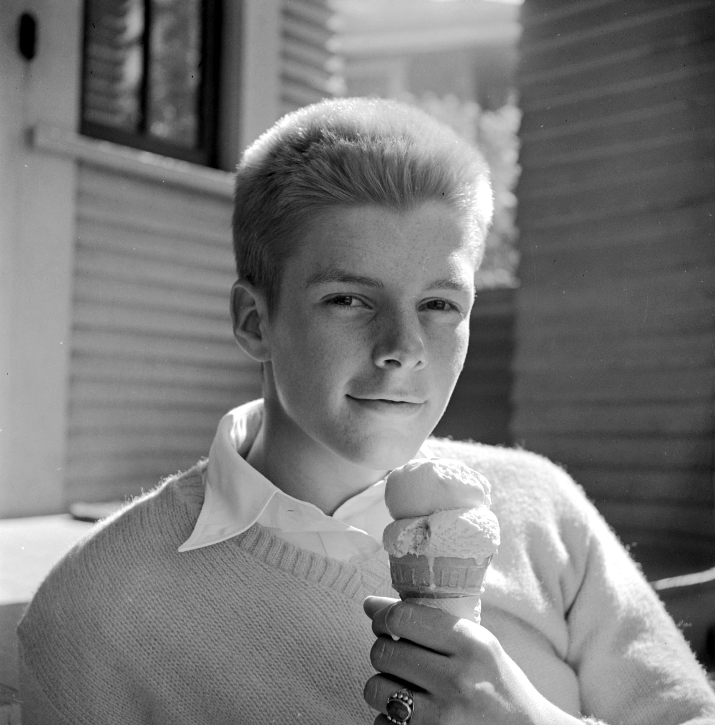 A teenage boy in Iowa eating ice cream, 1945.