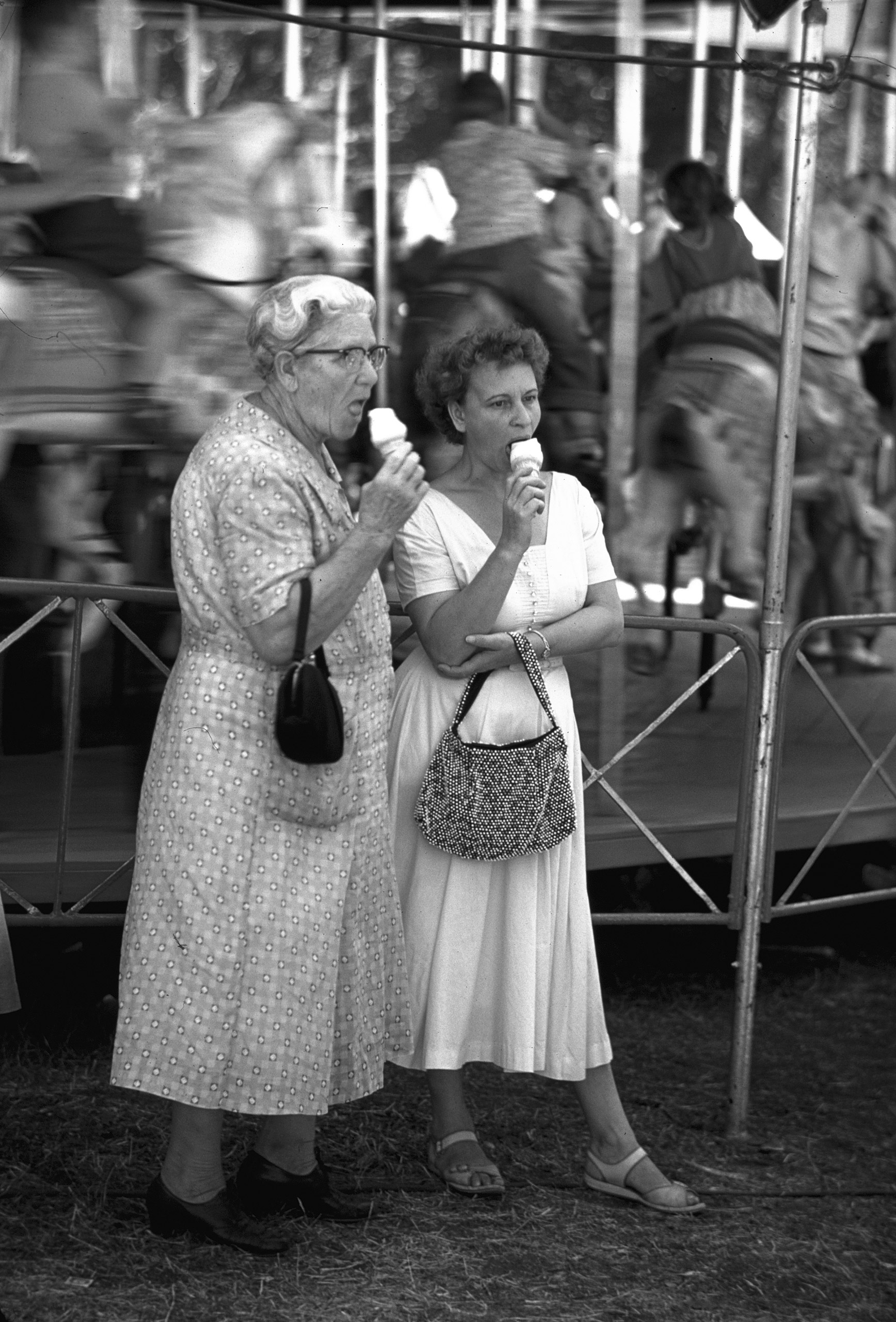 Two women enjoying ice cream cones at Iowa State Fair, 1955.