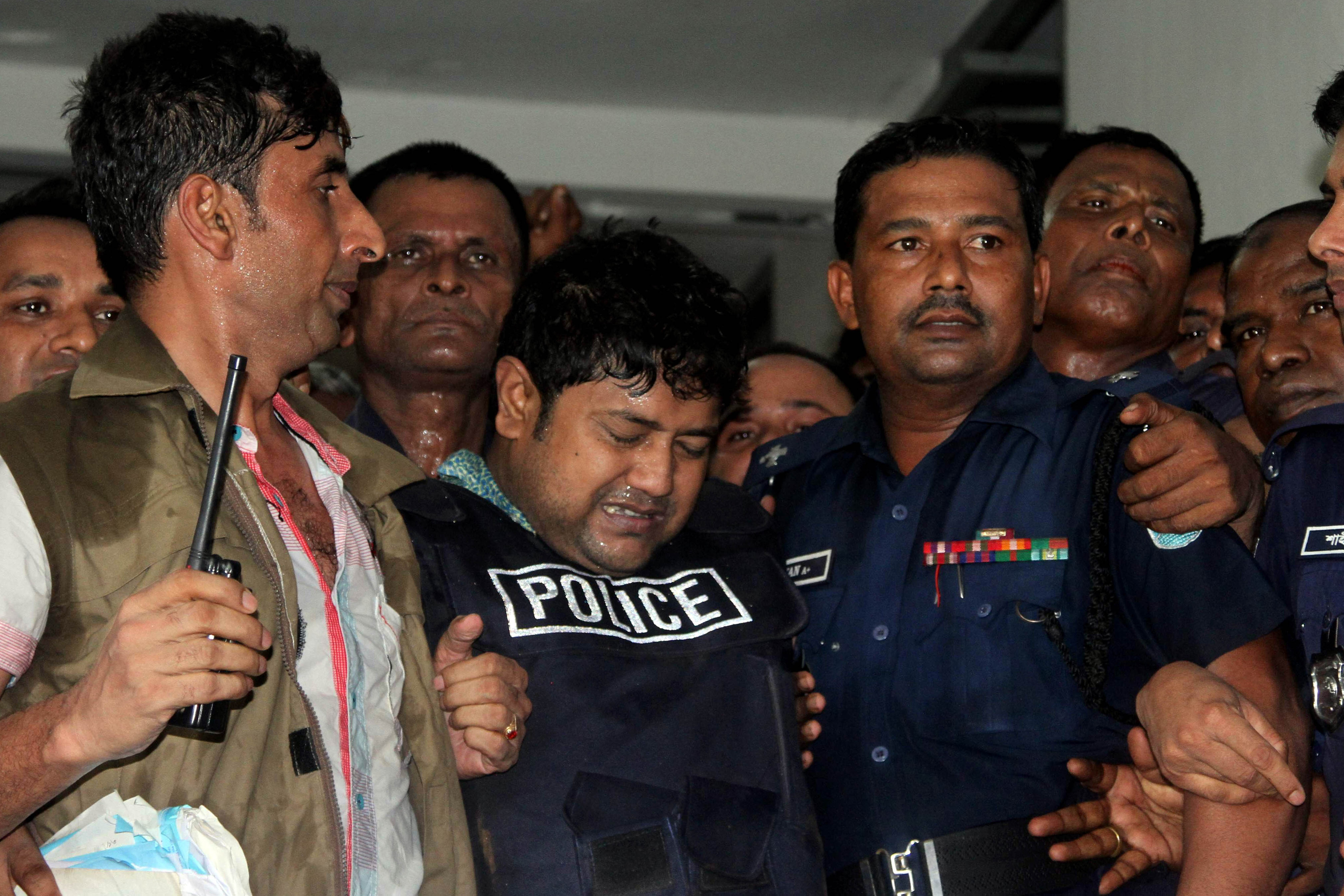 Bangladeshi property tycoon Sohel Rana (C), seen wearing police-issue body armor, is escorted for his appearance in court in Dhaka on April 29, 2013. (AFP—AFP/Getty Images)