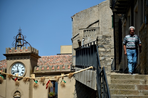 A man walks in the center of the village of Gangi, 120 kms from Palermo, on August 14, 2014 (Tiziana Fabi—AFP/Getty Images)