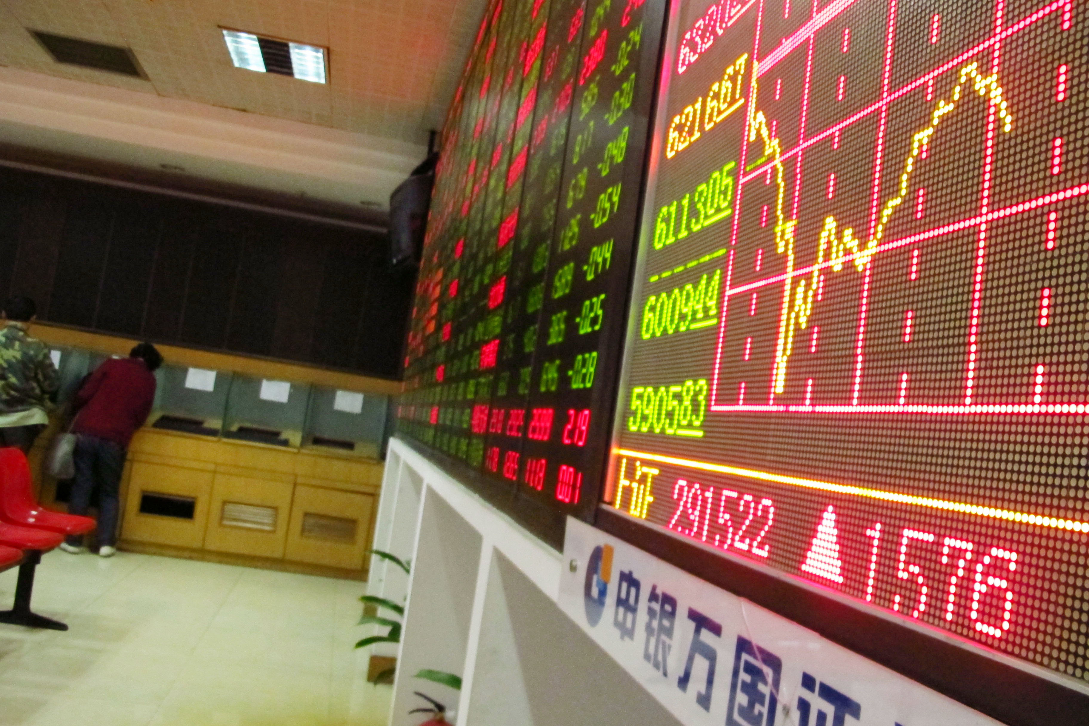 Investors watch the electronic board at a stock exchange hall on December 5, 2014 in Haikou, China. (ChinaFotoPress&mdash;ChinaFotoPress via Getty Images)
