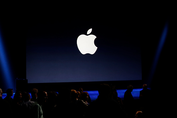 An Apple logo is seen on screen during an event in San Francisco on March 9, 2015.
