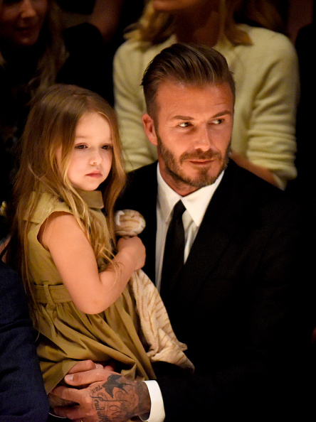 Harper Beckham (L) and David Beckham attend the Burberry "London in Los Angeles" event in Los Angeles on April 16, 2015.