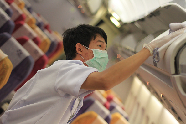 Thai Airways (THAI)  implements preventive measures regarding the MERS virus on THAI flights within  affected areas; Thai officers spray disinfectant on passenger seats aboard a Thai Airways Airbus A330-300 at Suvarnabhumi airport in Bangkok (Pacific Press—LightRocket via Getty Images)