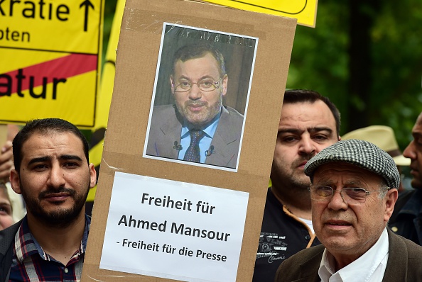 Supporters of ousted Egyptian Islamist president Mohamed Morsi stage a demonstration to ask for the release of detained Al-Jazeera journalist Ahmed Mansour in front of the local court of Berlin's Tiergarten district, where Mansour is being held in custody on June 21, 2015 (JOHN MACDOUGALL—AFP/Getty Images)