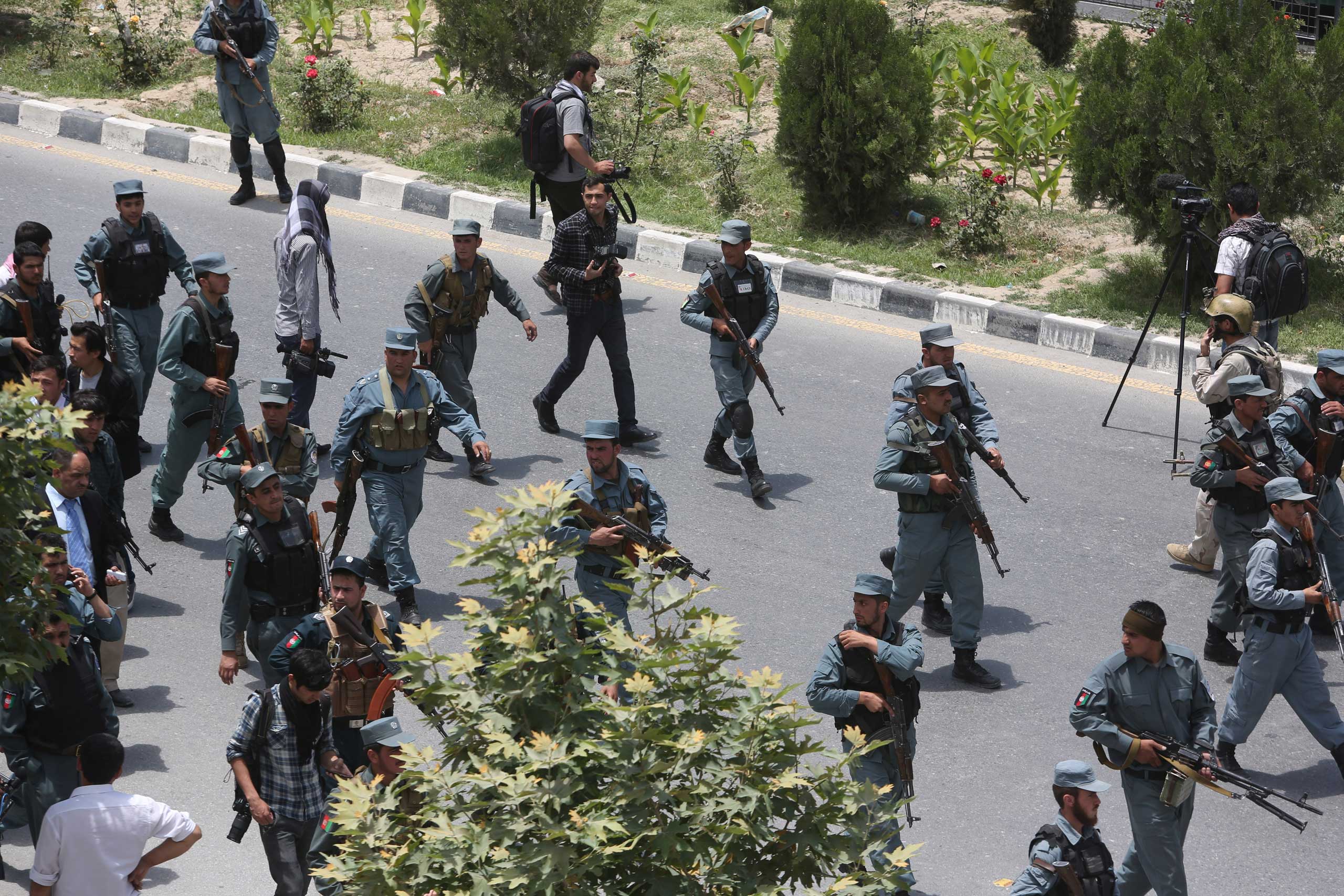 Afghan security forces inspect the site of a suicide attack after clashes with Taliban fighters in front of the Afghan Parliament, in Kabul, Afghanistan on June 22, 2015.