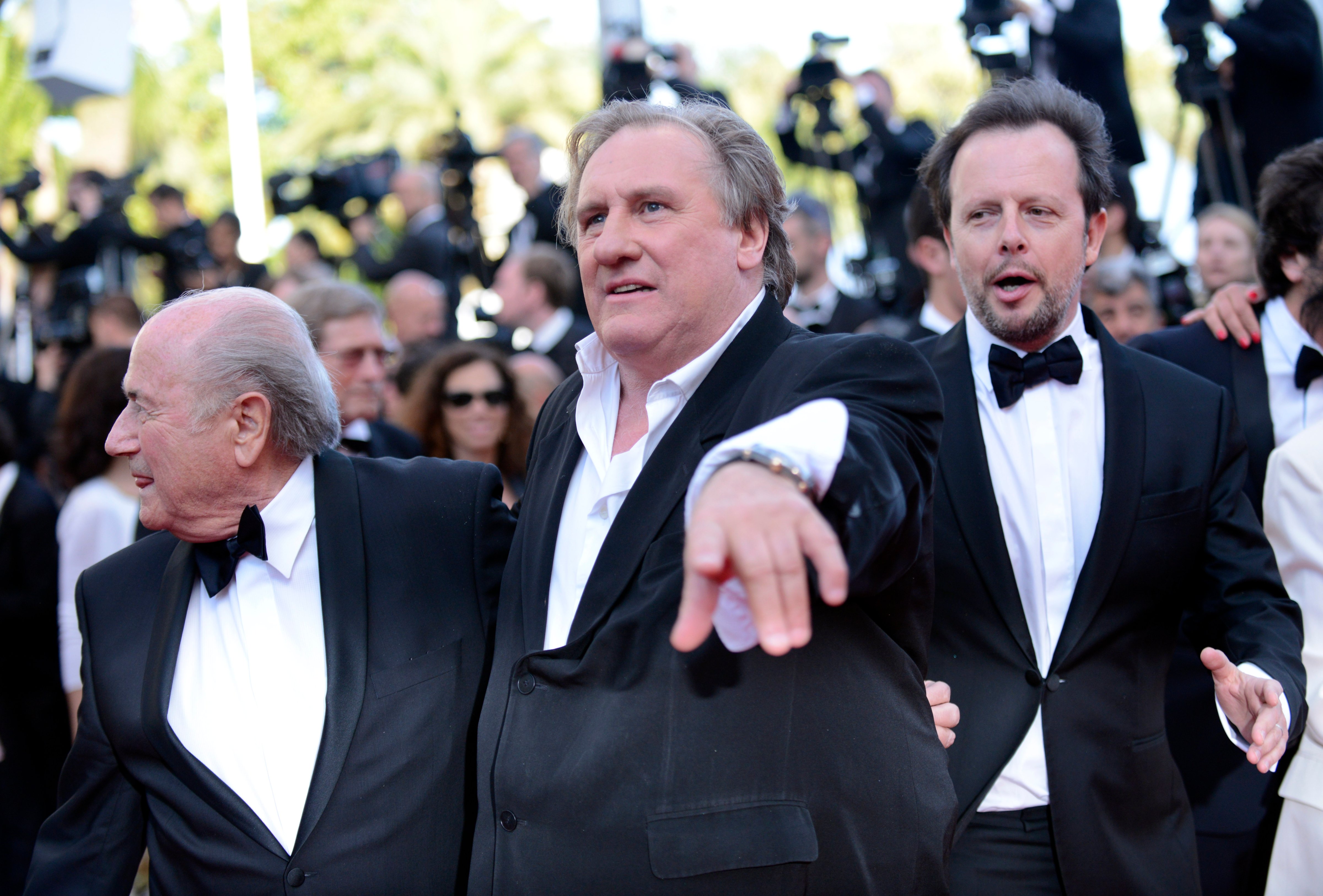 FIFA President Sepp Blatter, Gerard Depardieu and Frederic Auburtin arrive for the screening of The Homesman at the 67th international film festival, Cannes, southern France, May 18, 2014. (Arthur Mola — Invision/AP)