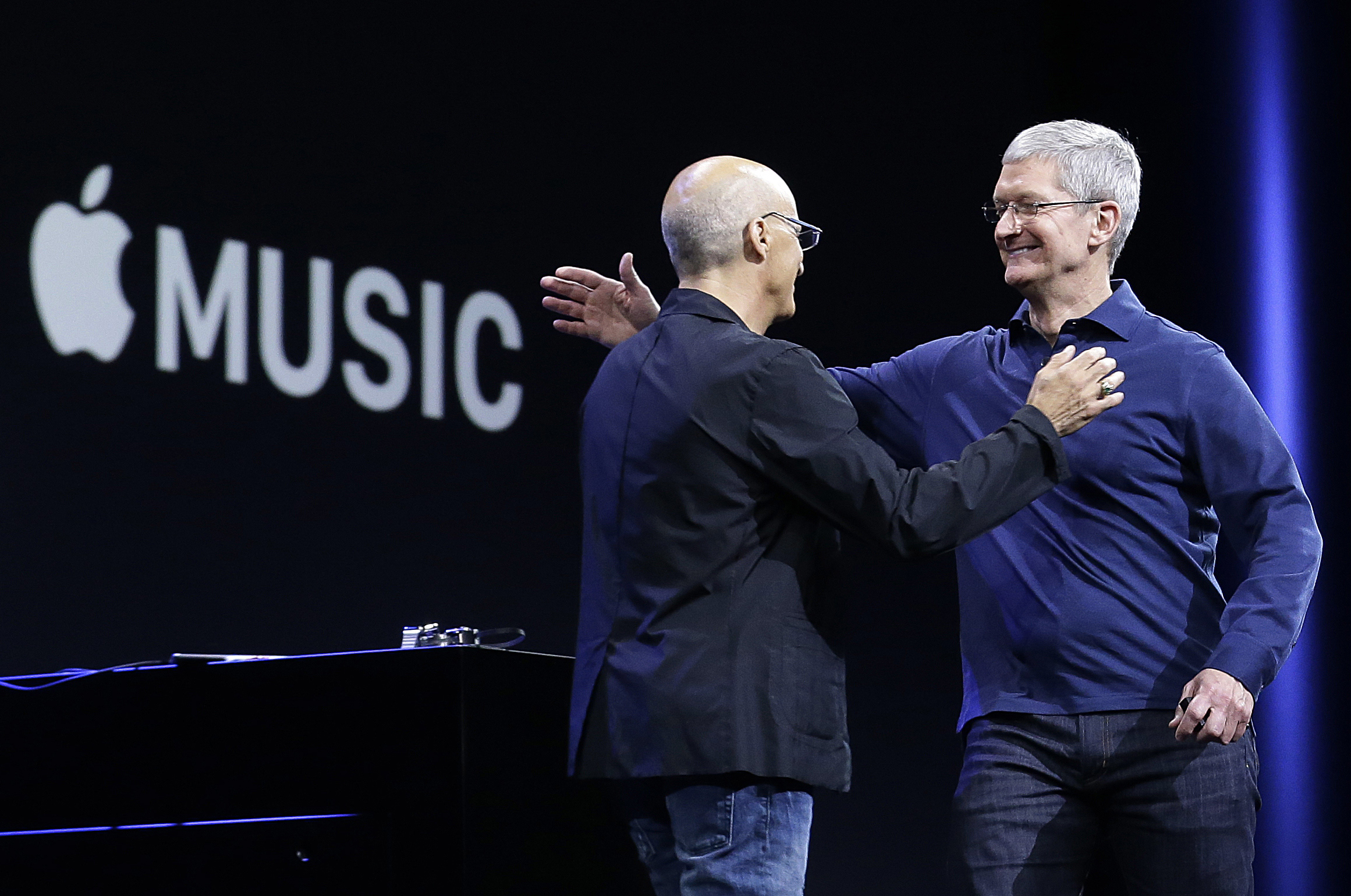 Apple CEO Tim Cook, right, hugs Beats by Dre co-founder and Apple employee Jimmy Iovine at the Apple Worldwide Developers Conference in San Francisco, Monday, June 8, 2015. (Jeff Chiu&mdash;AP)