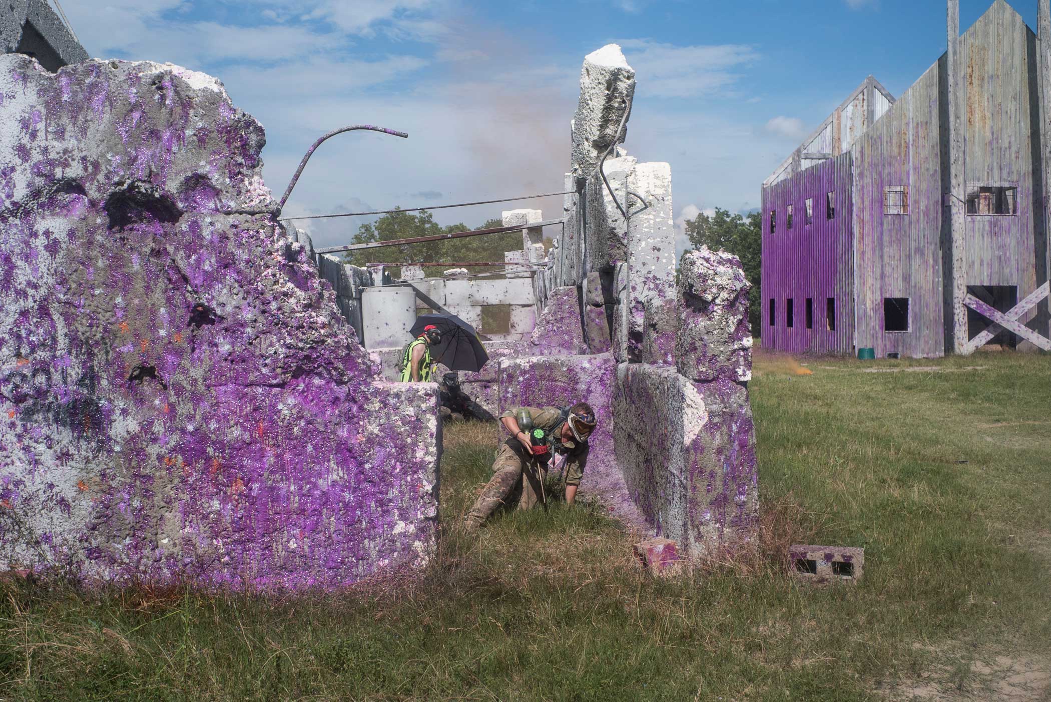 A paintballer takes cover in the town of “Colleville,” which is turned increasingly purple by paintballs over the course of the week.