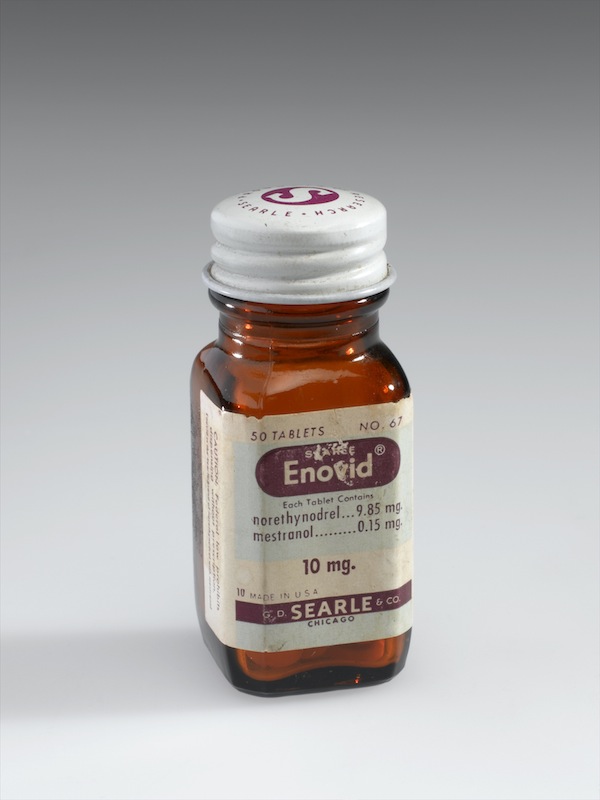 Bottle of Enovid tabs 10mg, early 1960s. Front three quarter view. Graduated grey background.