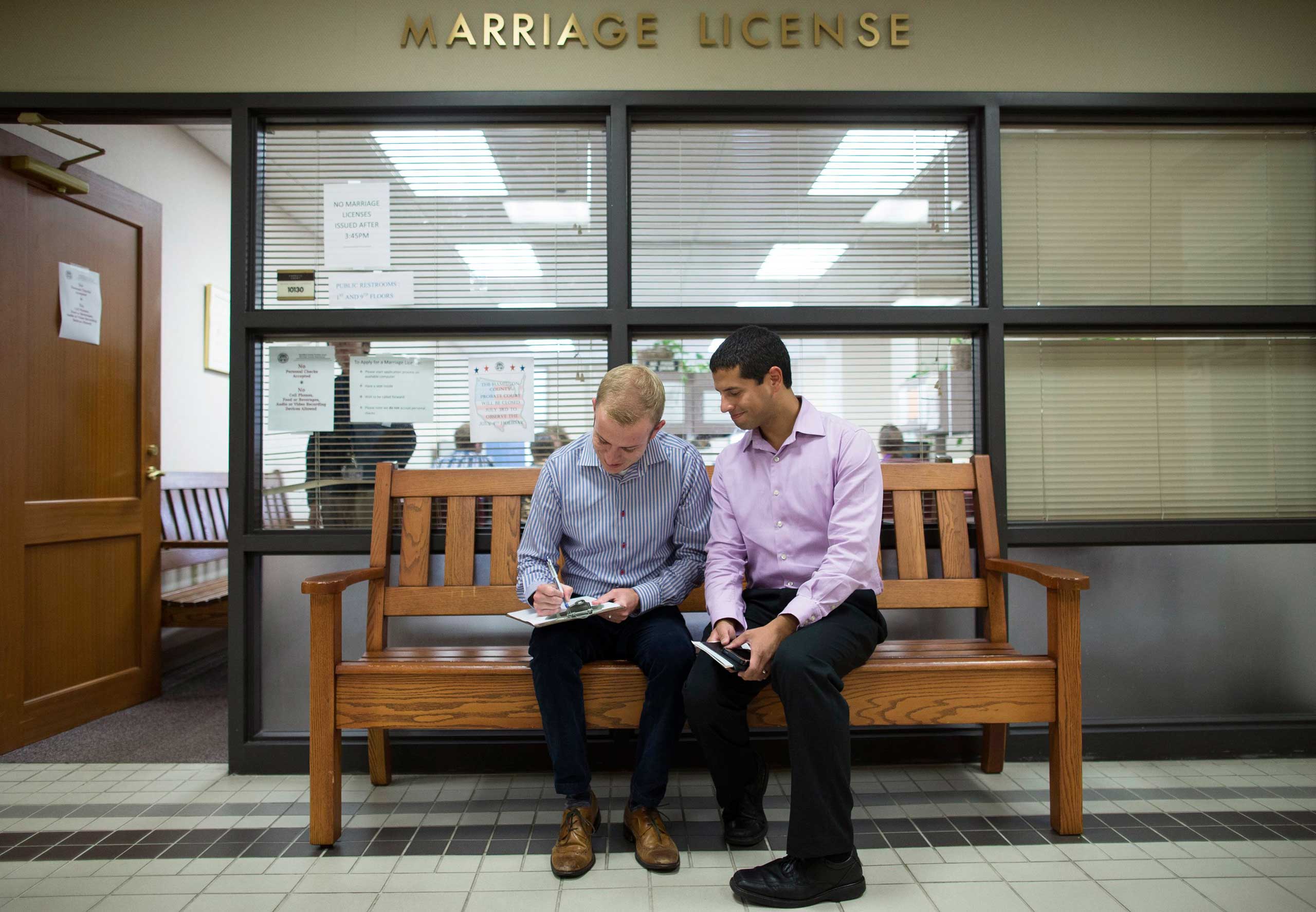 Ethan Fletcher, left, and Andrew Hickam fill out their marriage paperwork at Hamilton County Probate Court in Cincinnati on June 26, 2015.