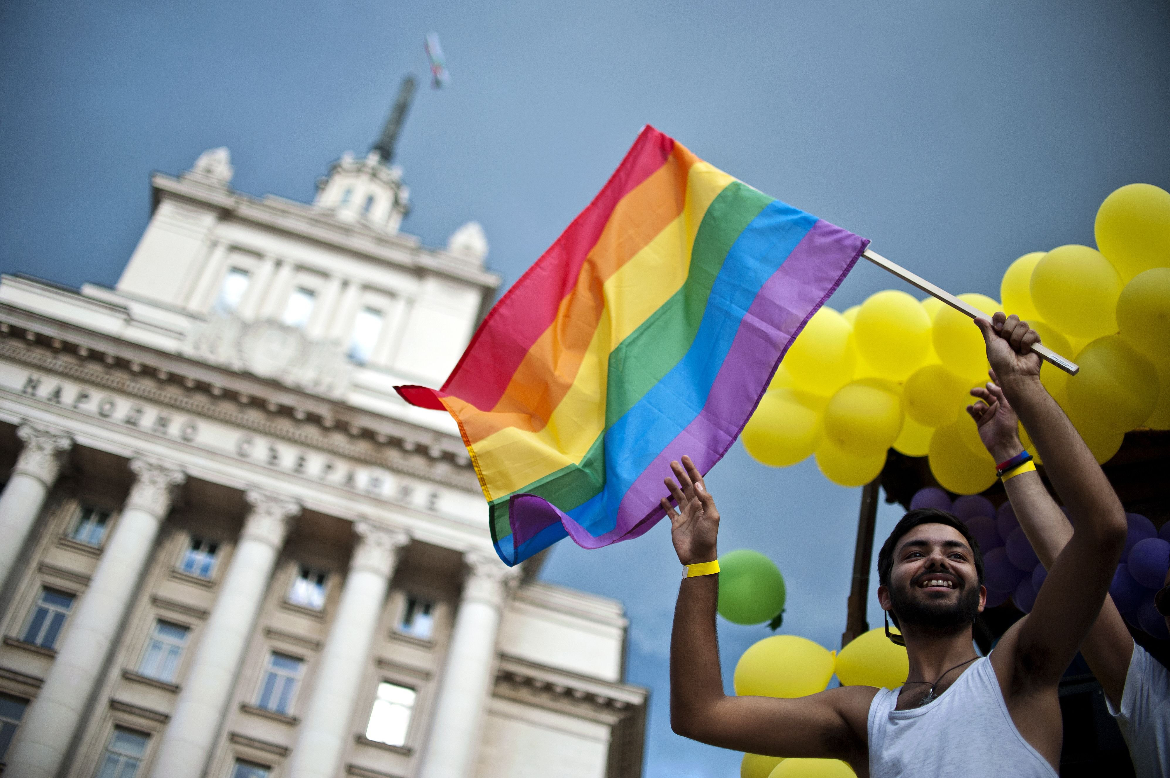 A man waves the Rainbow flag on a truck during the annual Gay Pride parade in central Sofia, Bulgaria on June 27, 2015.