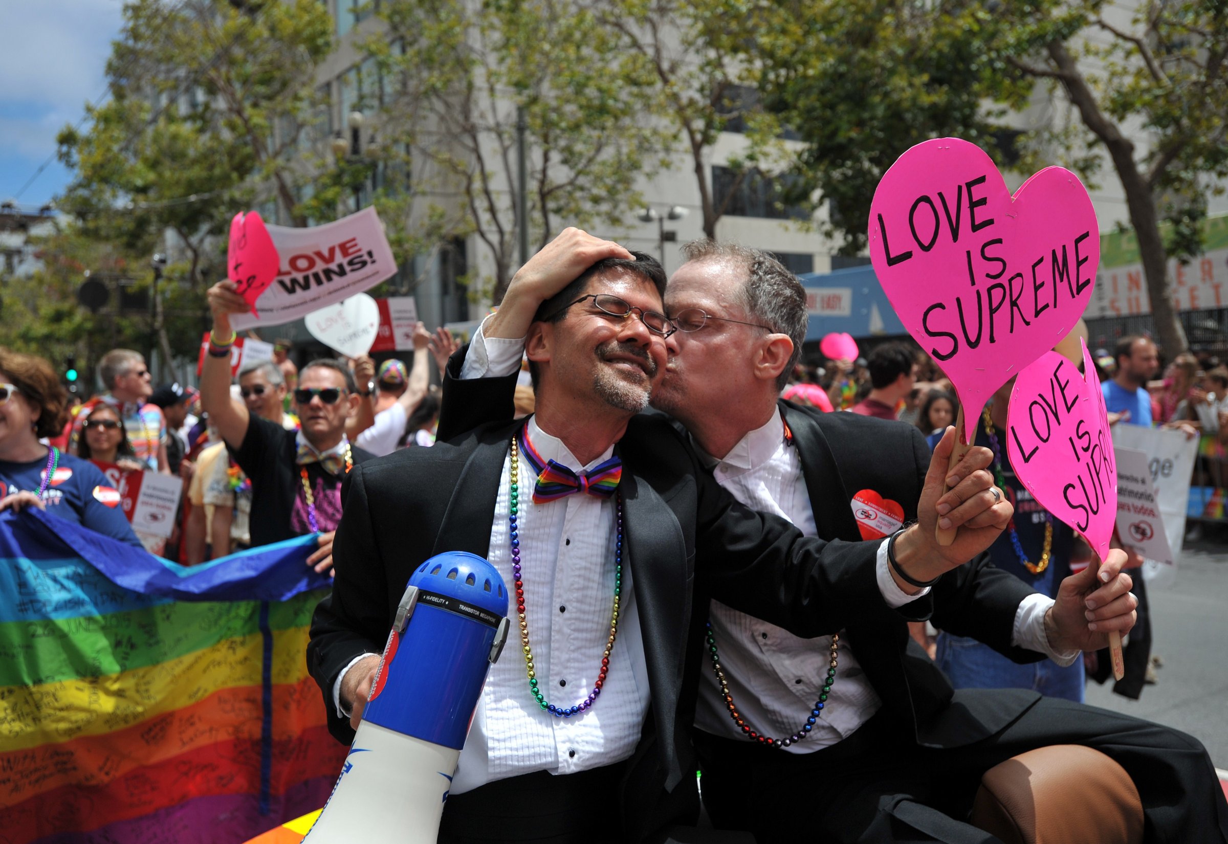 Stuart Gaffney (L) and John Lewis, plaintiffs in the 2008 Defense of Marriage Act (DOMA) case, celebrate while traveling along Market Street during the annual Gay Pride Parade in San Francisco, California on June 28, 2015, two days after the US Supreme Court's landmark ruling legalizing same-sex marriage nationwide.
