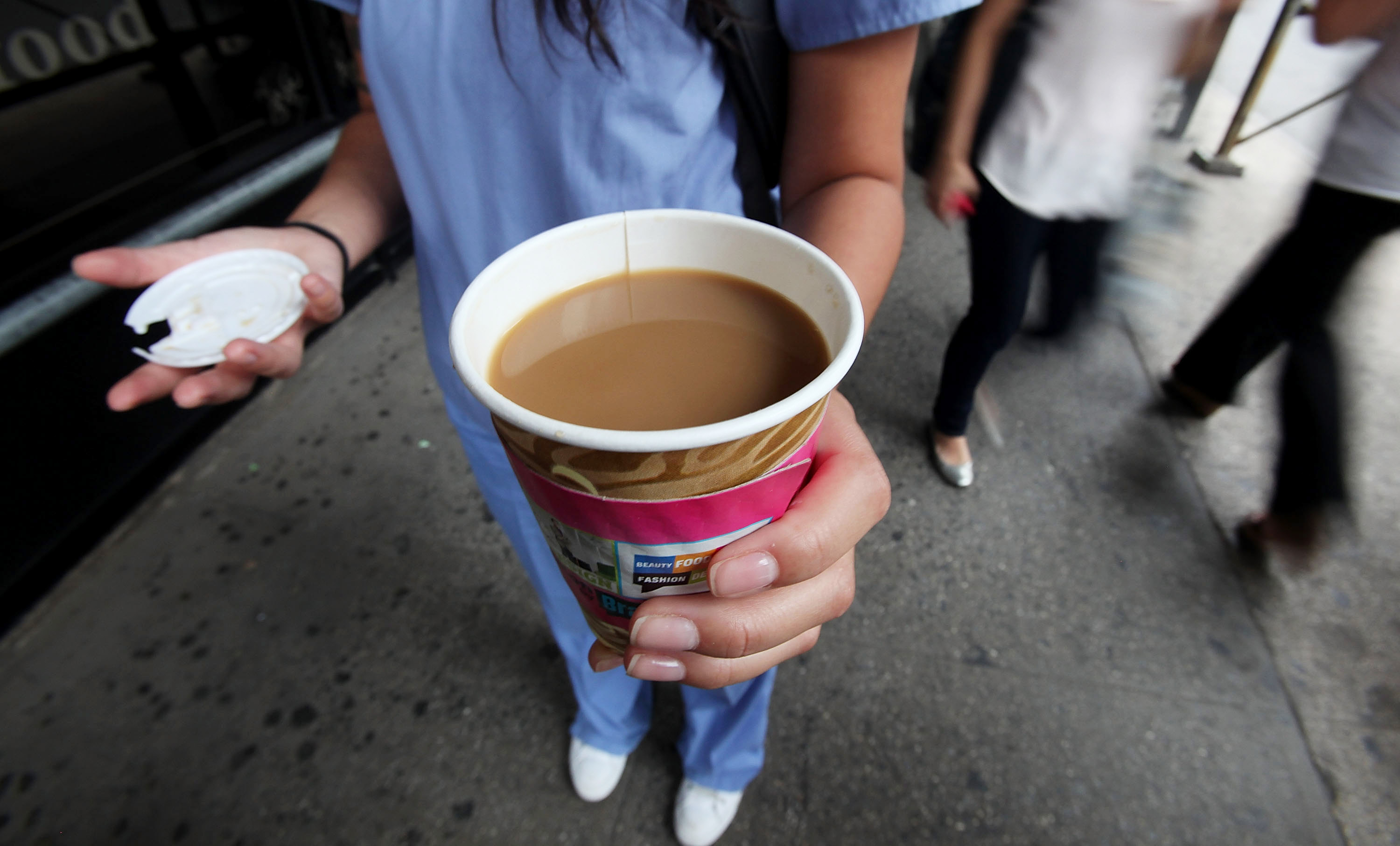 In this Photo Illustration, a woman holds a cup of coffee on the street August 3, 2010 in New York City. (Mario Tama&mdash;Getty Images)