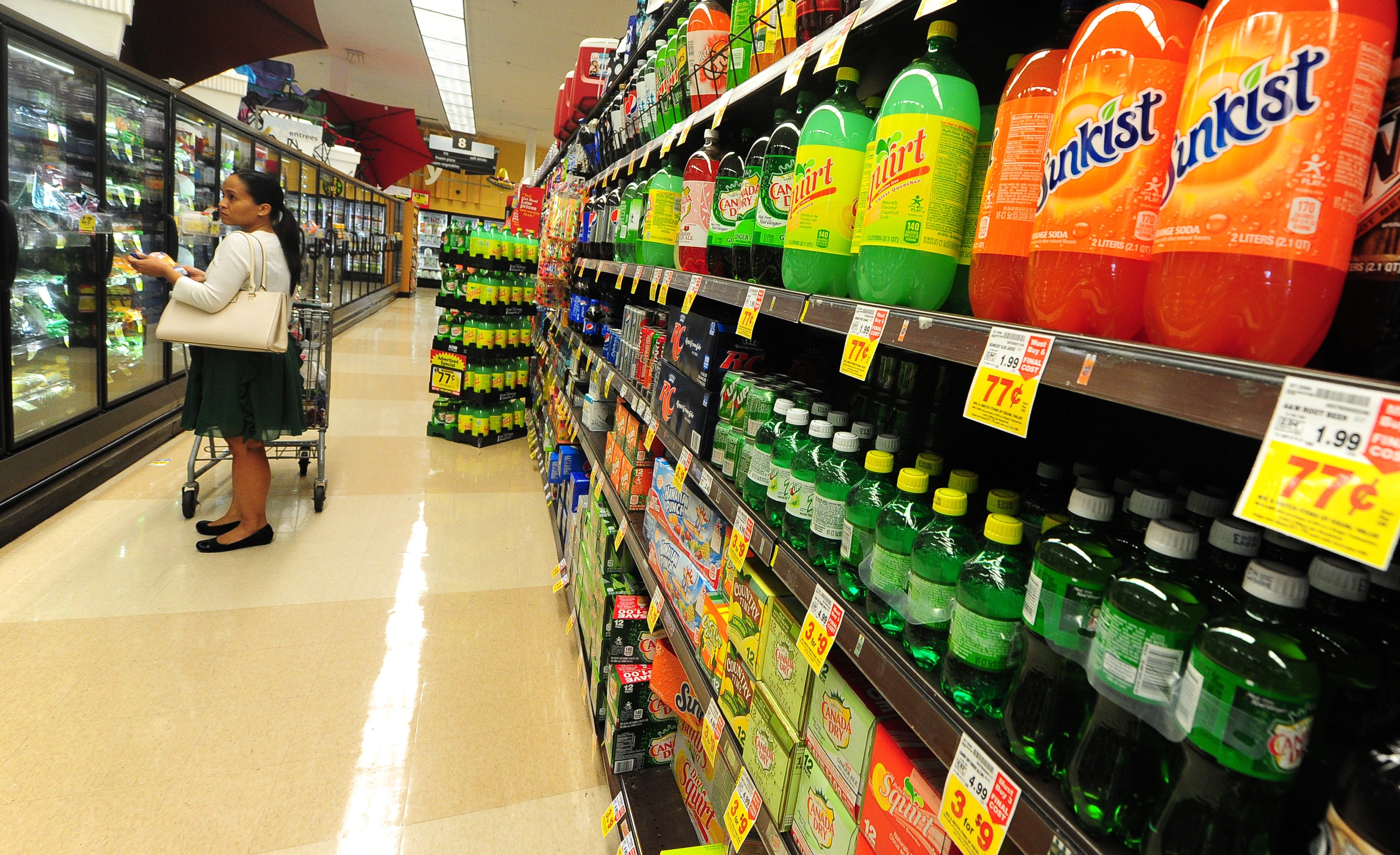 A woman shops for frozen foods on an aisle across from sodas and other sugary drinks for sale at a superrmarket in Monterey Park, California on June 18, 2014. (Frederic J. Brown—AFP/Getty Images)