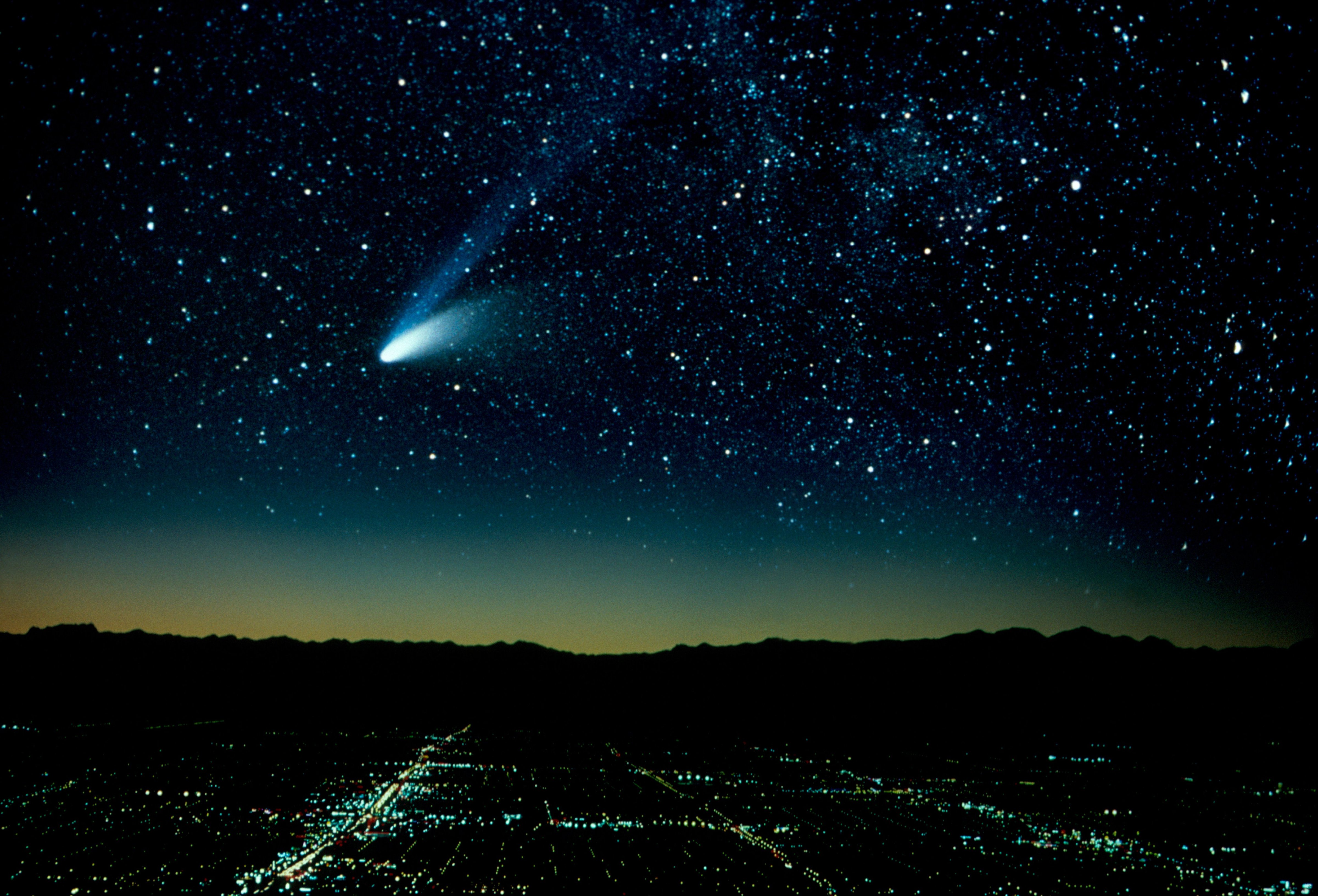 Hale-Bopp Comet And City At Night (Composite). (Education Images&mdash;UIG via Getty Images)