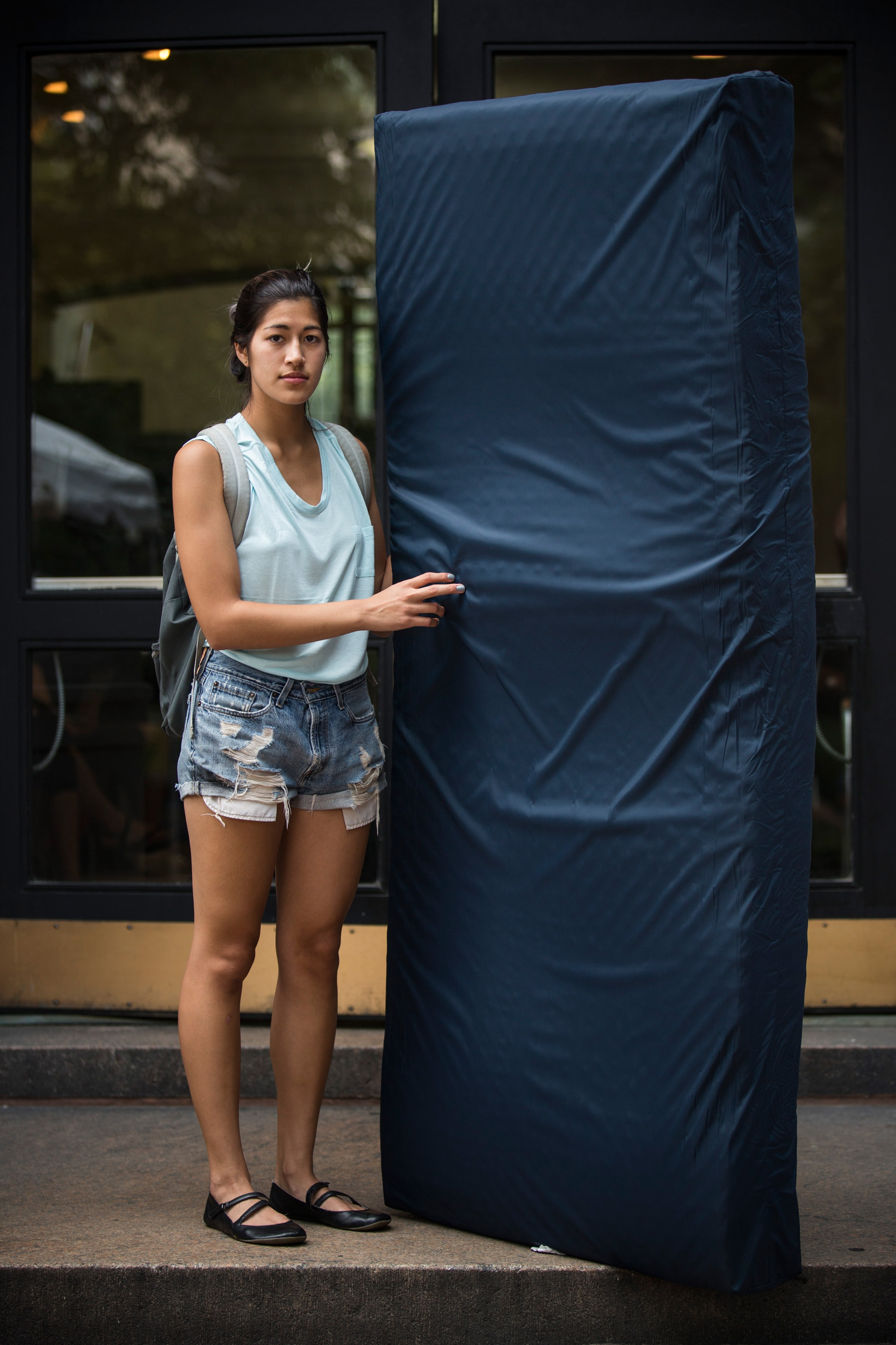 Emma Sulkowicz, a senior visual arts student at Columbia University, poses with a mattress, which she says she will carry every where she goes in protest of the university's lack of action after she reported being raped during her sophomore year, on September 5, 2014 in New York City. (Andrew Burton--Getty Images) (Andrew Burton&mdash;Getty Images)