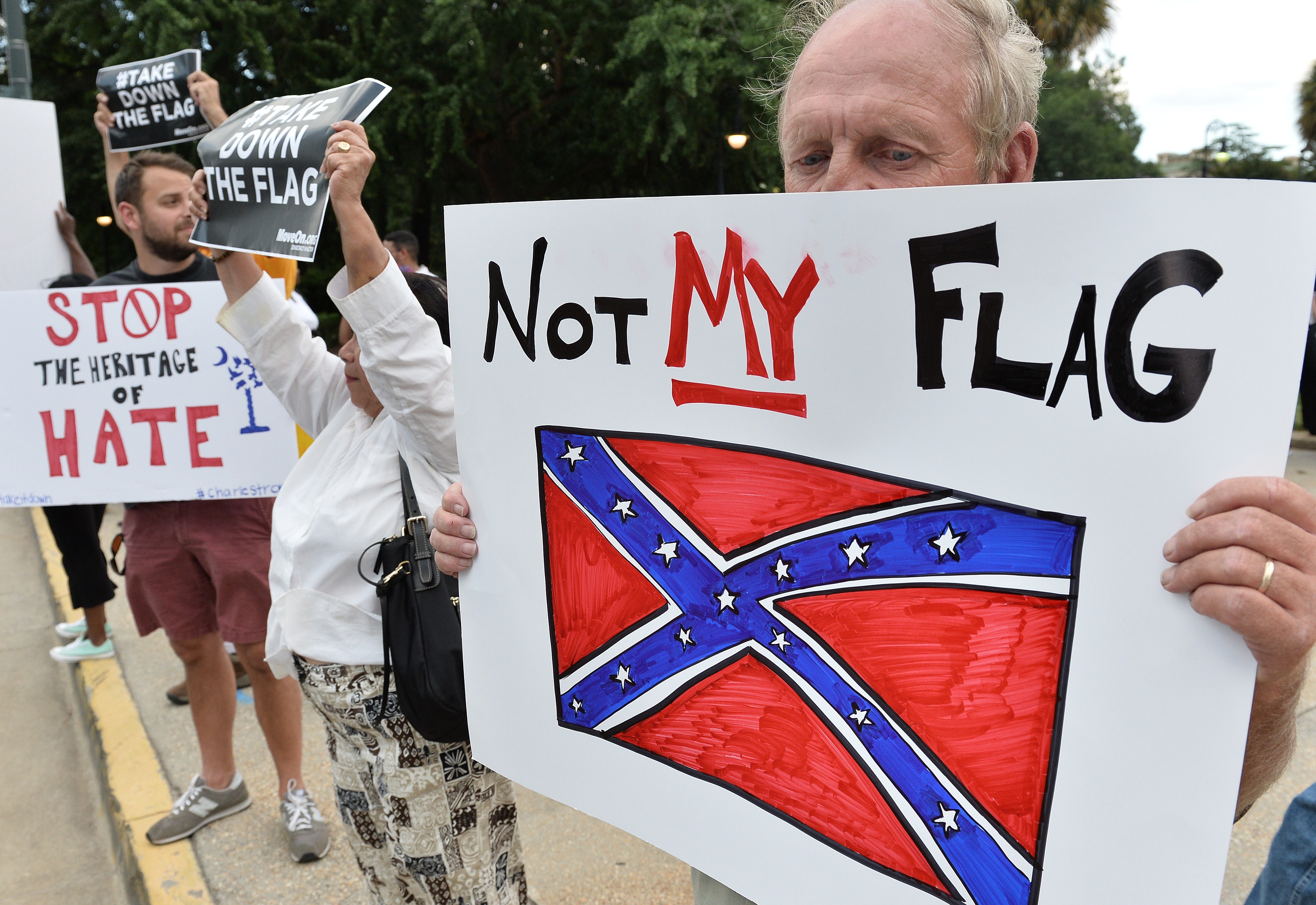 A man holds a sign up during a protest rally against the Confederate flag in Columbia, South Carolina on June 20, 2015. (MLADEN ANTONOV / AFP/Getty Images)