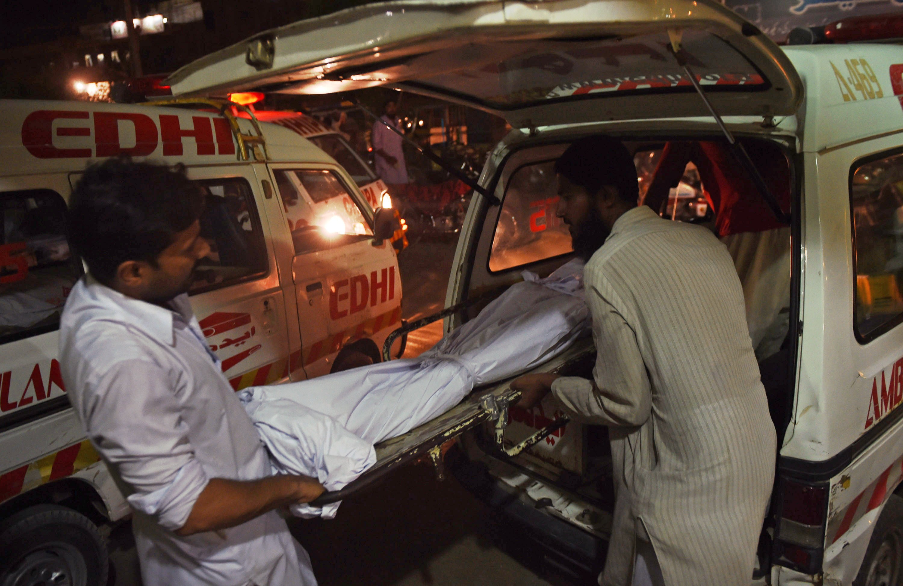 Relatives shift the dead body of a heatwave victim into an ambulance at the EDHI morgue in Karachi on June 21, 2015. (Asif Hassan—AFP/Getty Images)