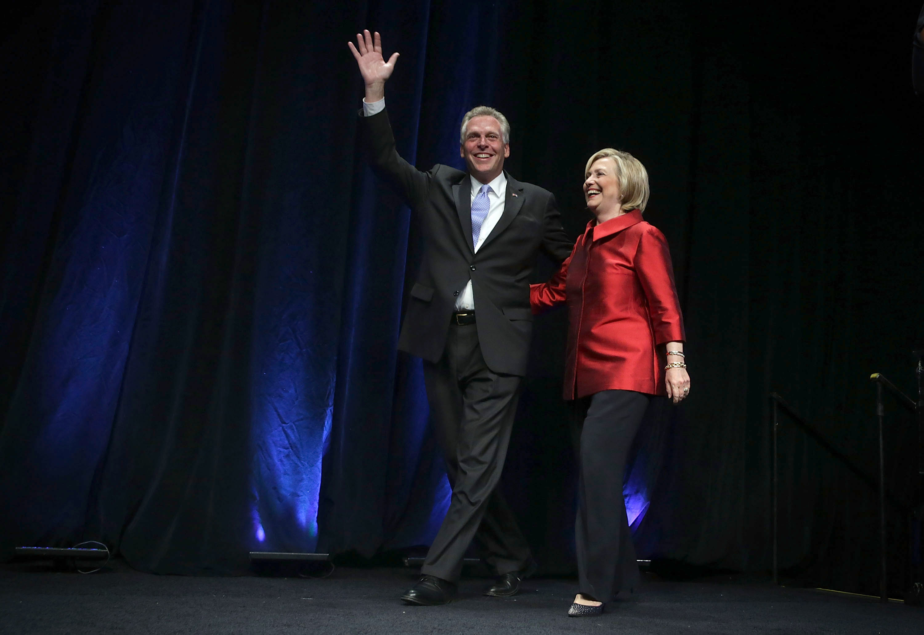 Democratic U.S. presidential hopeful and former U.S. Secretary of the State Hillary Clinton comes on the stage with Virginia Governor Terry McAuliffe during the Democratic Party of Virginia Jefferson-Jackson dinner June 26, 2015 at George Mason University's Patriot Center in Fairfax, Virginia. (Alex Wong—Getty Images)