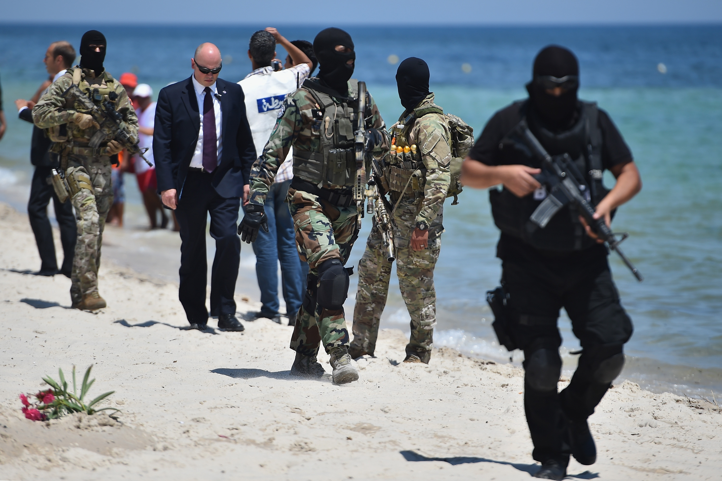Armed guards patrol Marhaba beach during a visit by British Home Secretary Theresa May at the scene where 39 people were killed on June 29, in Sousse, Tunisia. (Jeff J Mitchell—Getty Images)
