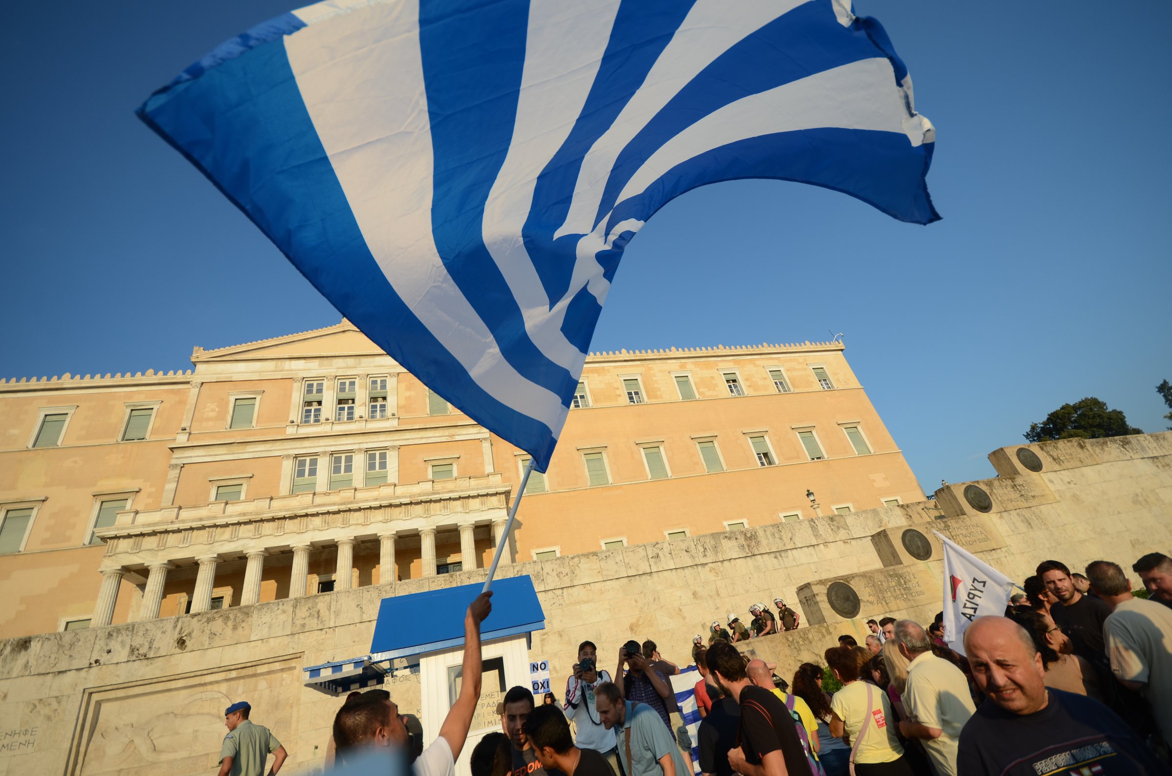 People waving flags at Syntagma square.  Greeks demonstrate