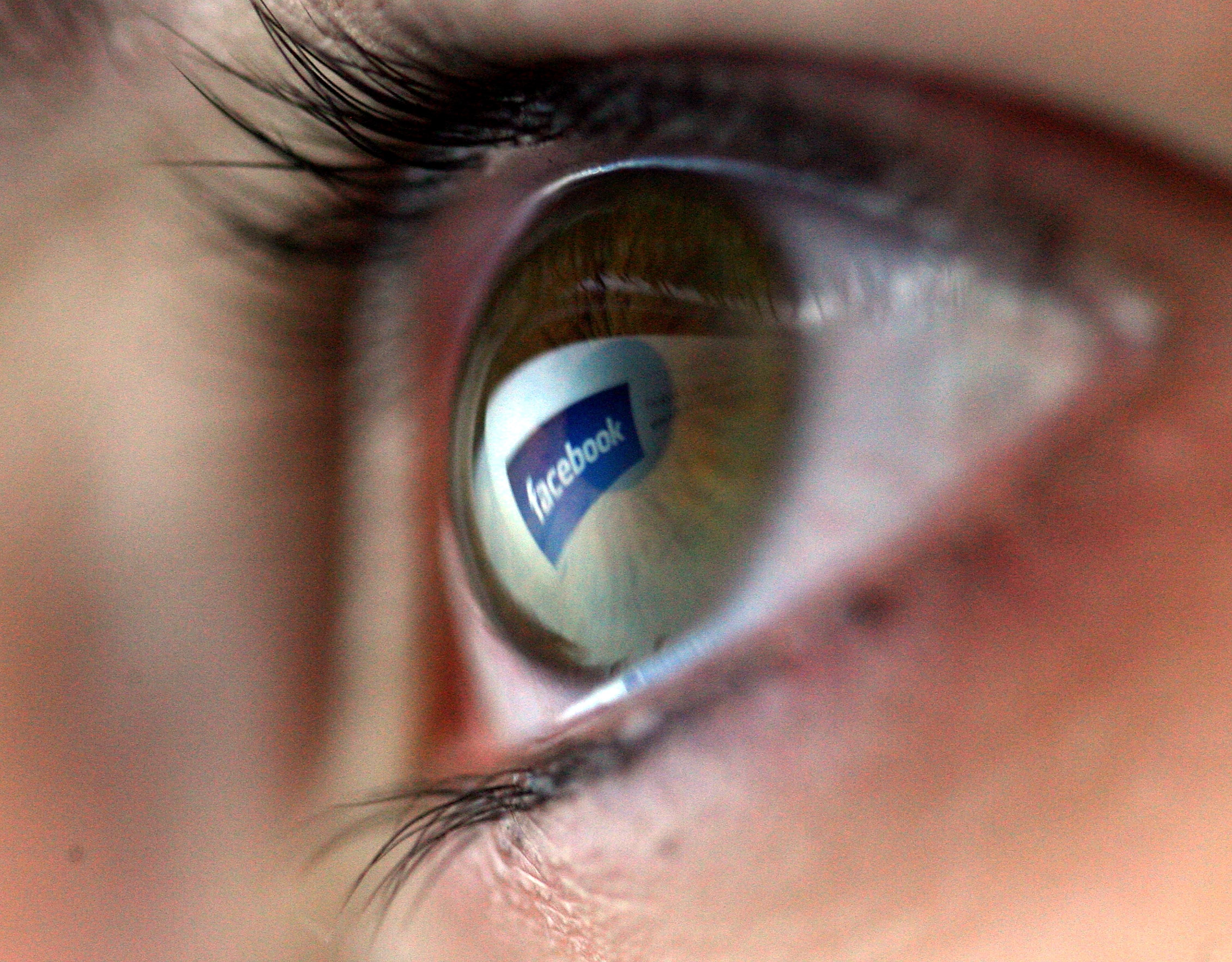 Facebook logo is reflected in the eye of a girl on February 3, 2008 in London, England. (Chris Jackson—Getty Images)