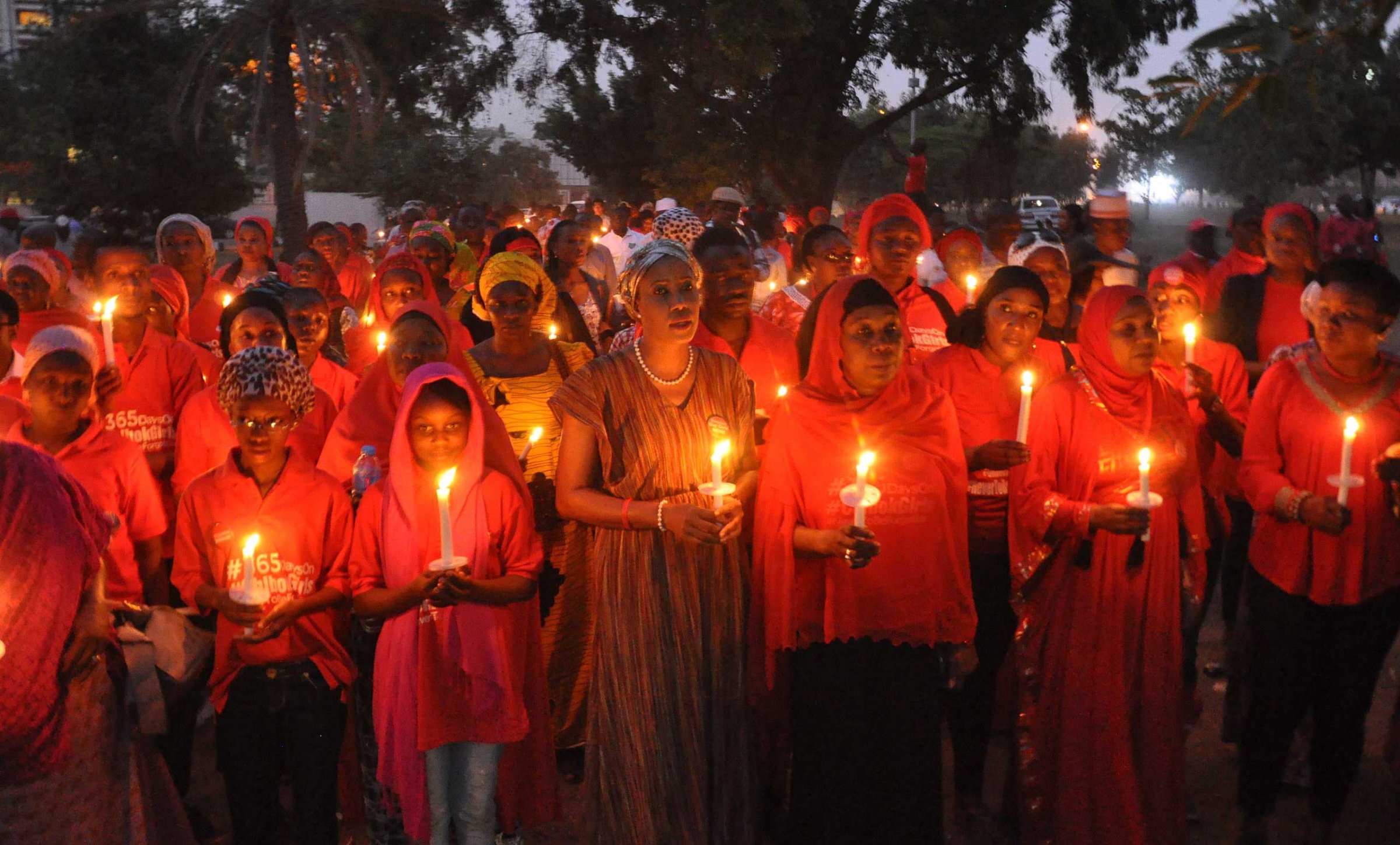 Nigerians holding candles during a vigil for the one year anniversary of the kidnapping of hundreds of Nigerian school girls in Chibok, Abuja, Nigeria on April 14, 2015.