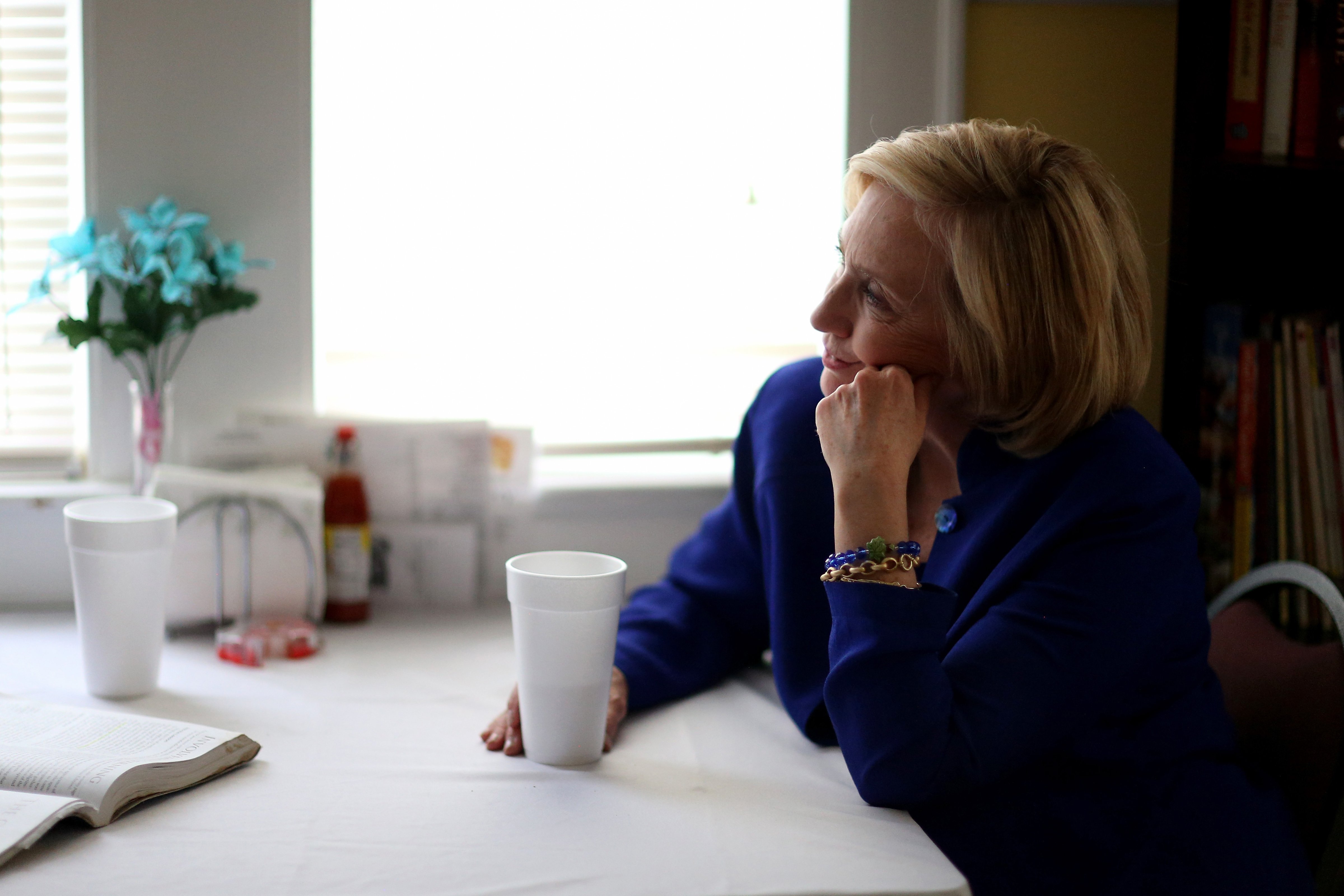 Democratic Presidential candidate Hillary Clinton sits with a customer as she visits the Main Street Bakery on May 27, 2015 in Columbia, SC. (Joe Raedle—Getty Images)